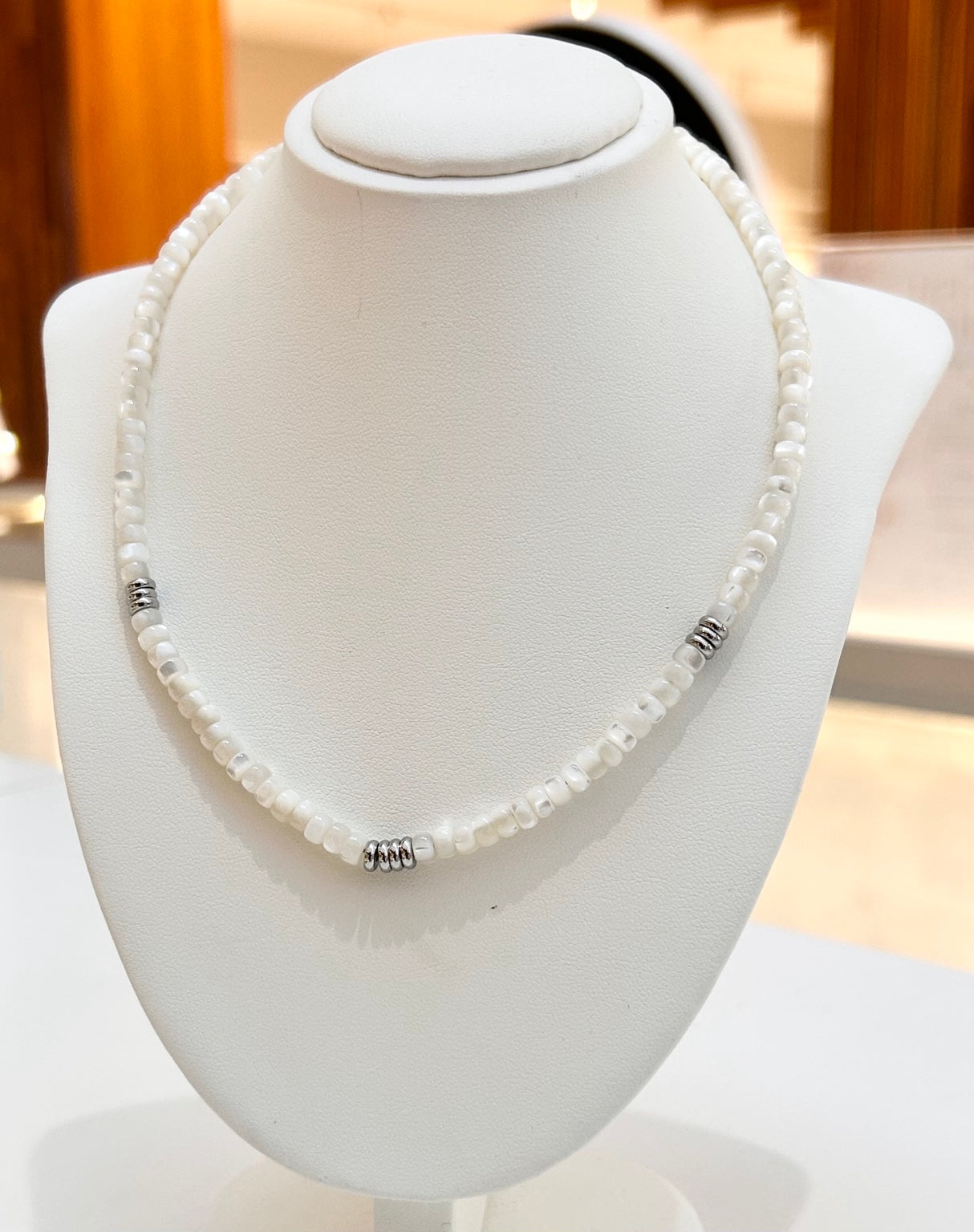 
                  
                    Avelisse pearl necklace with silver-tone details displayed on a jewellery bust
                  
                