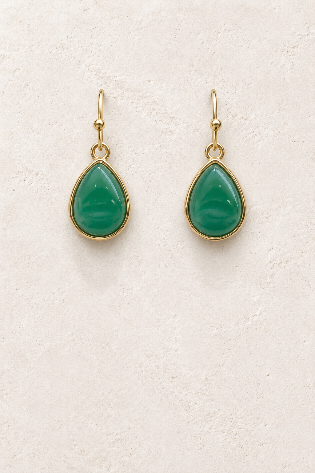 
                  
                    Aviana Green Jade Teardrop Earrings on cream plaster background
                  
                
