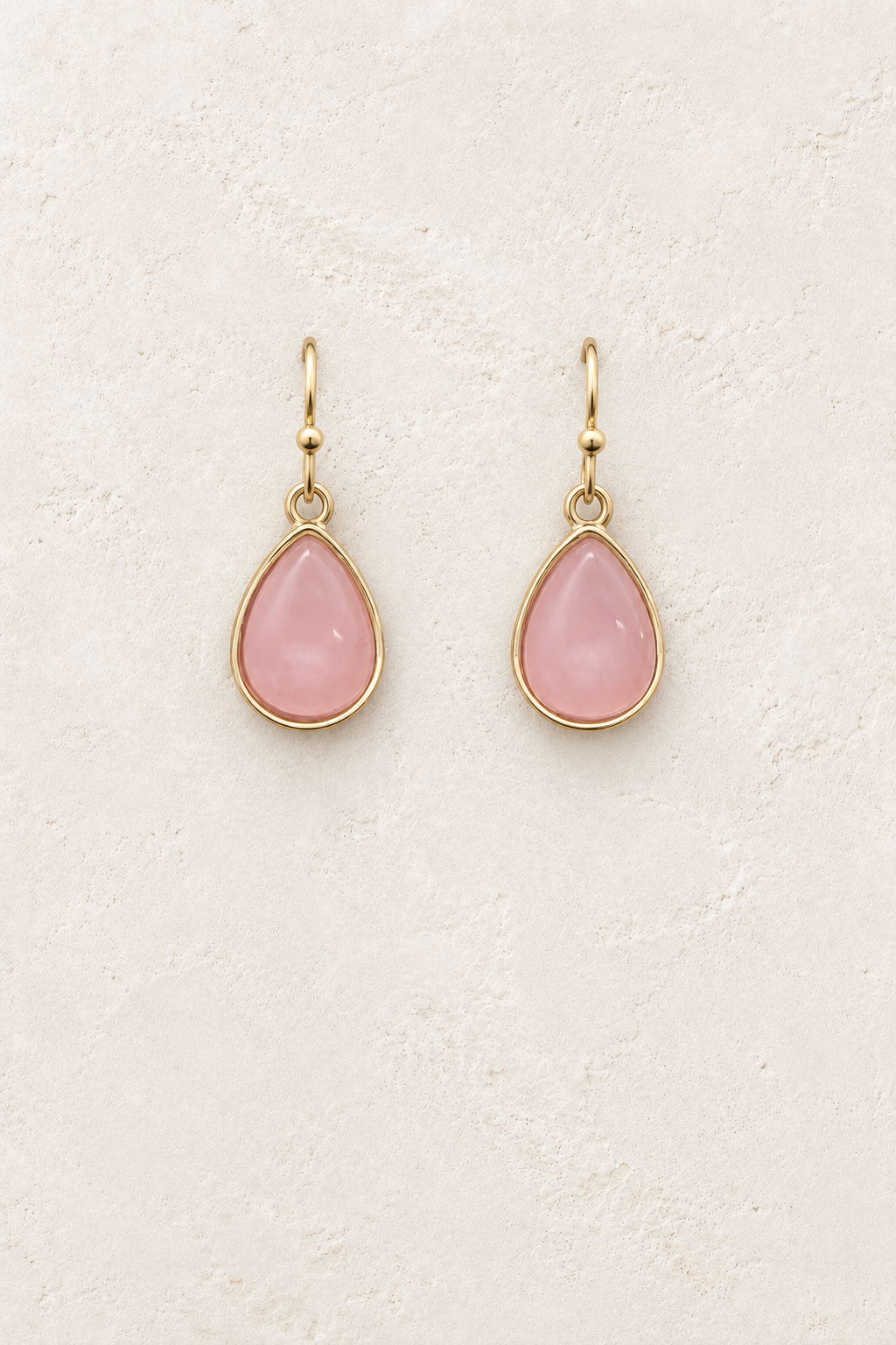 
                  
                    Aviana Pink Teardrop Earrings on cream plaster background
                  
                