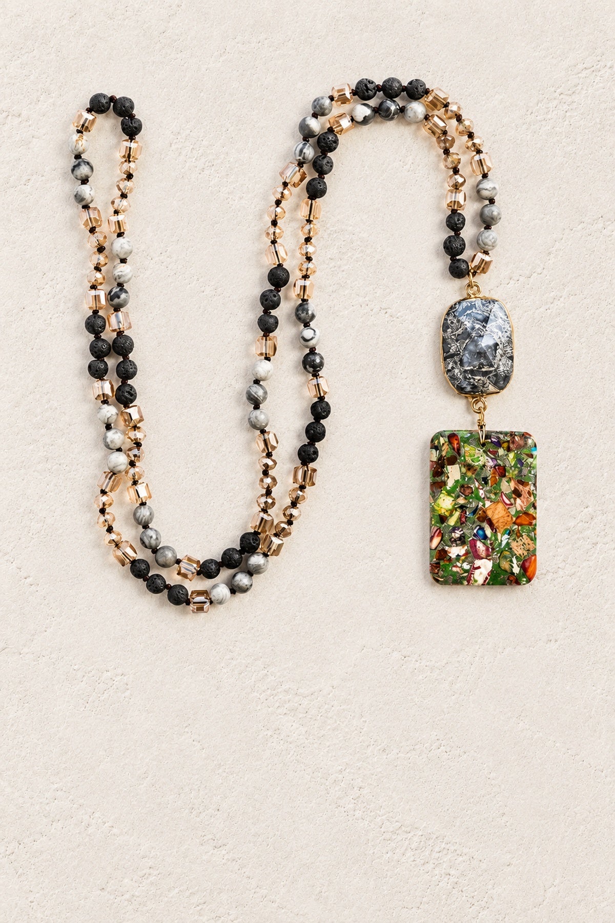 Black Agate Slice Tribal Necklace on warm cream plaster background