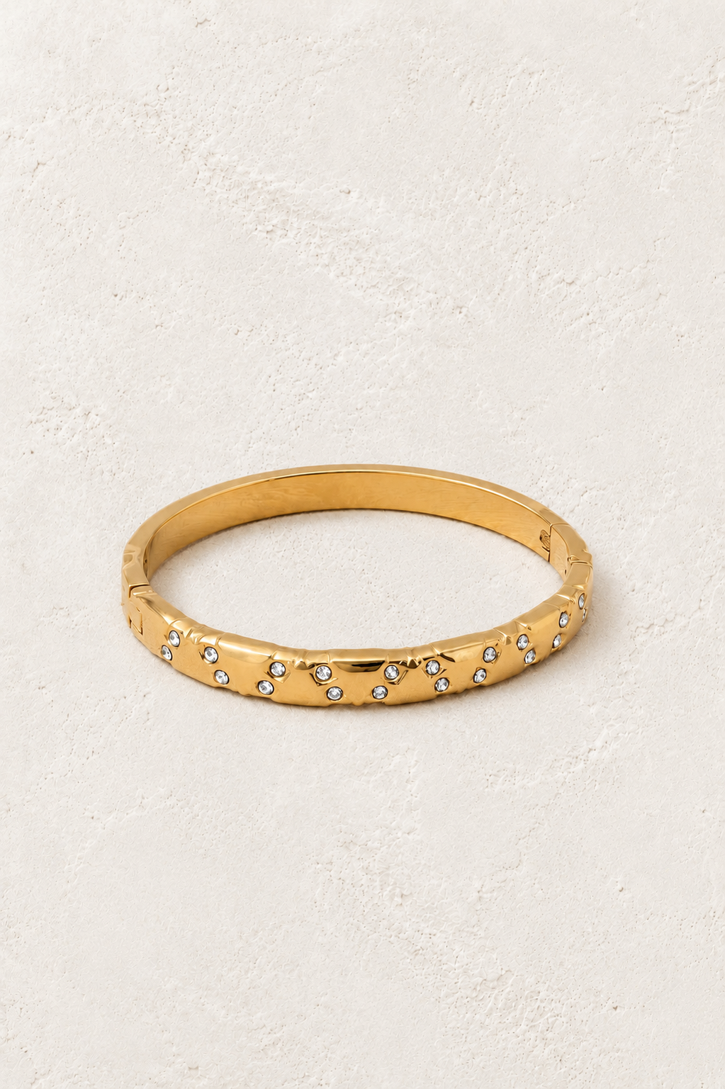 Stellara Textured Gold Scattered Crystal Bangle on Francesca's supplied original hero background