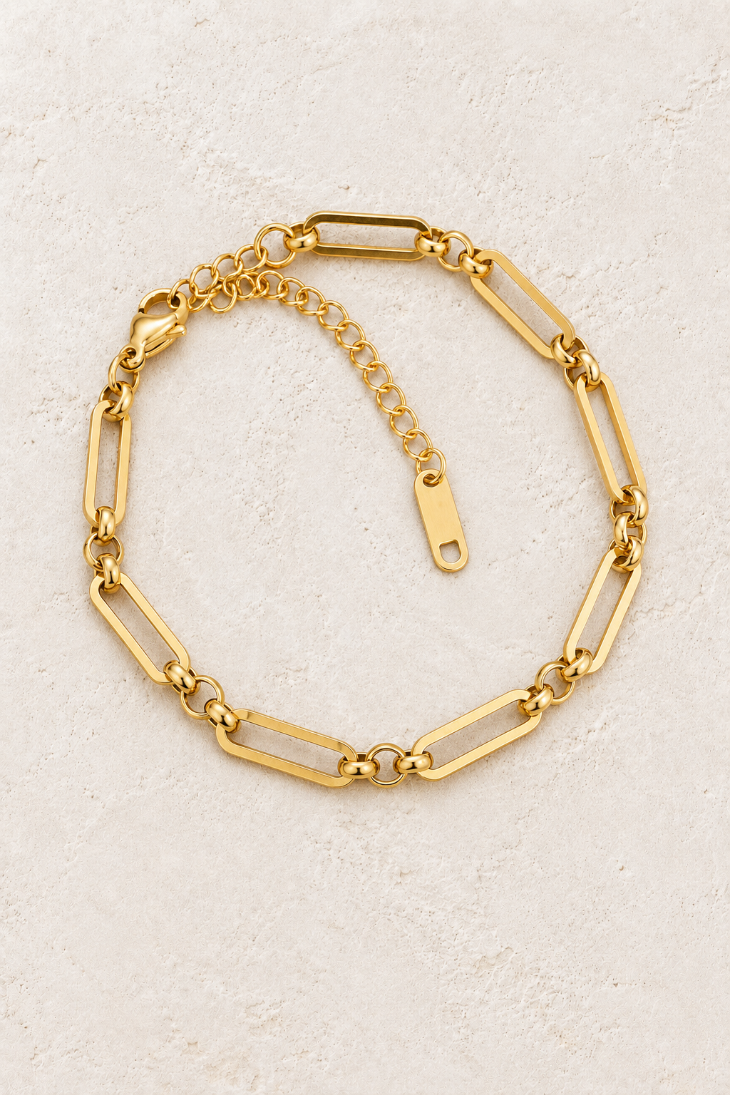 
                  
                    Gold Bold Paperclip Bracelet on ivory stone
                  
                