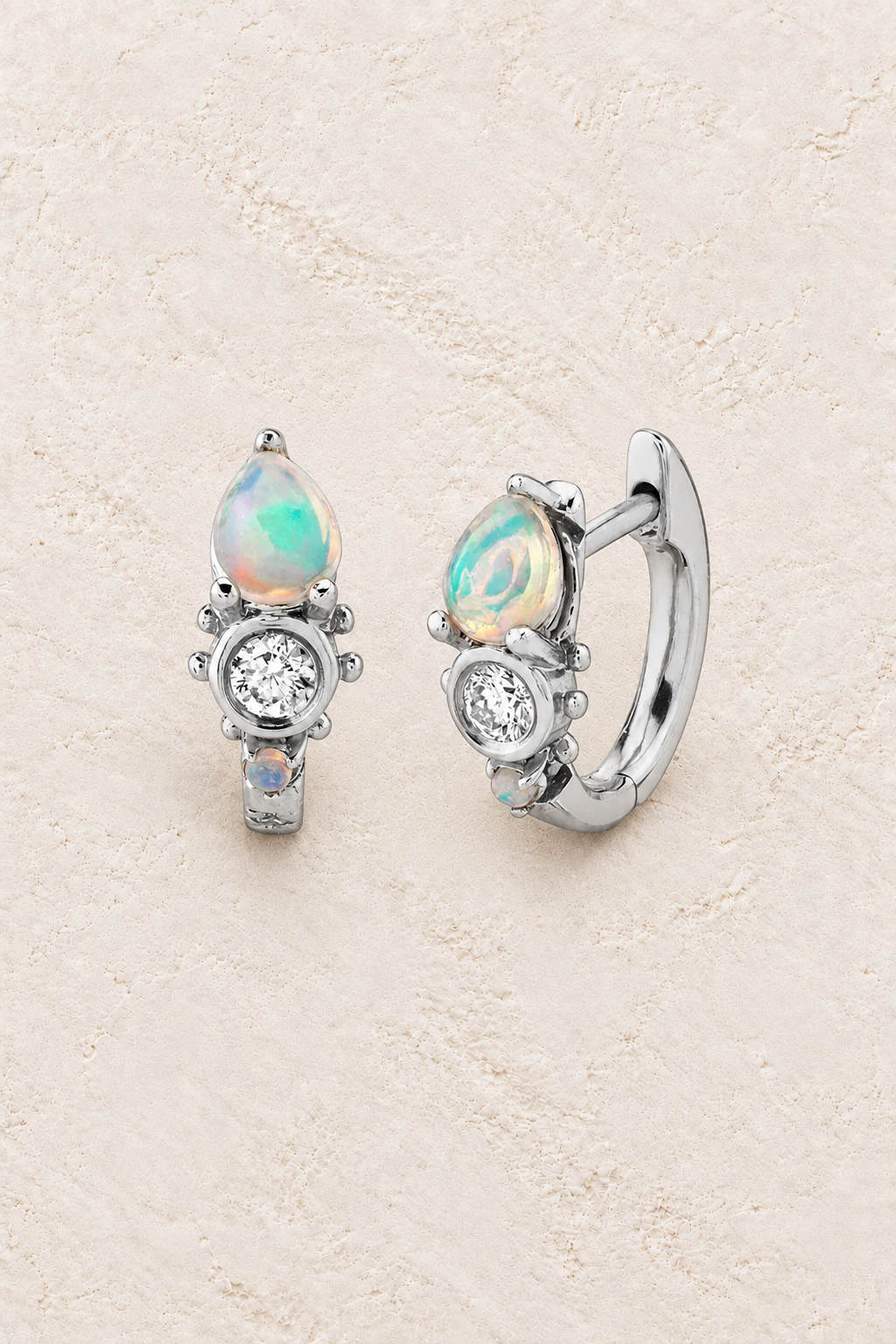 Boho & Mala Cubic Zirconia Opal Sterling Silver Hoop Huggie Earrings on warm cream textured background