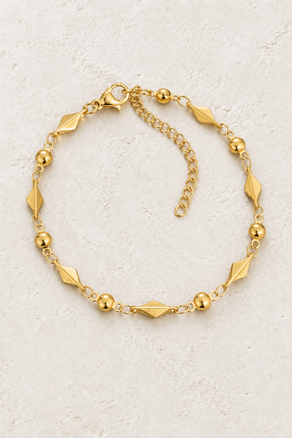 
                  
                    Gold Diamond & Bead Bracelet on ivory stone
                  
                
