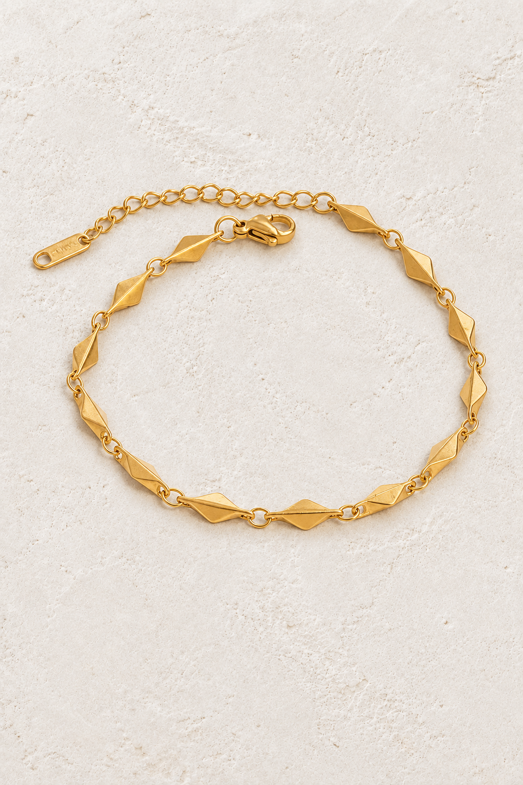 
                  
                    Gold Diamond Link Bracelet on ivory stone
                  
                