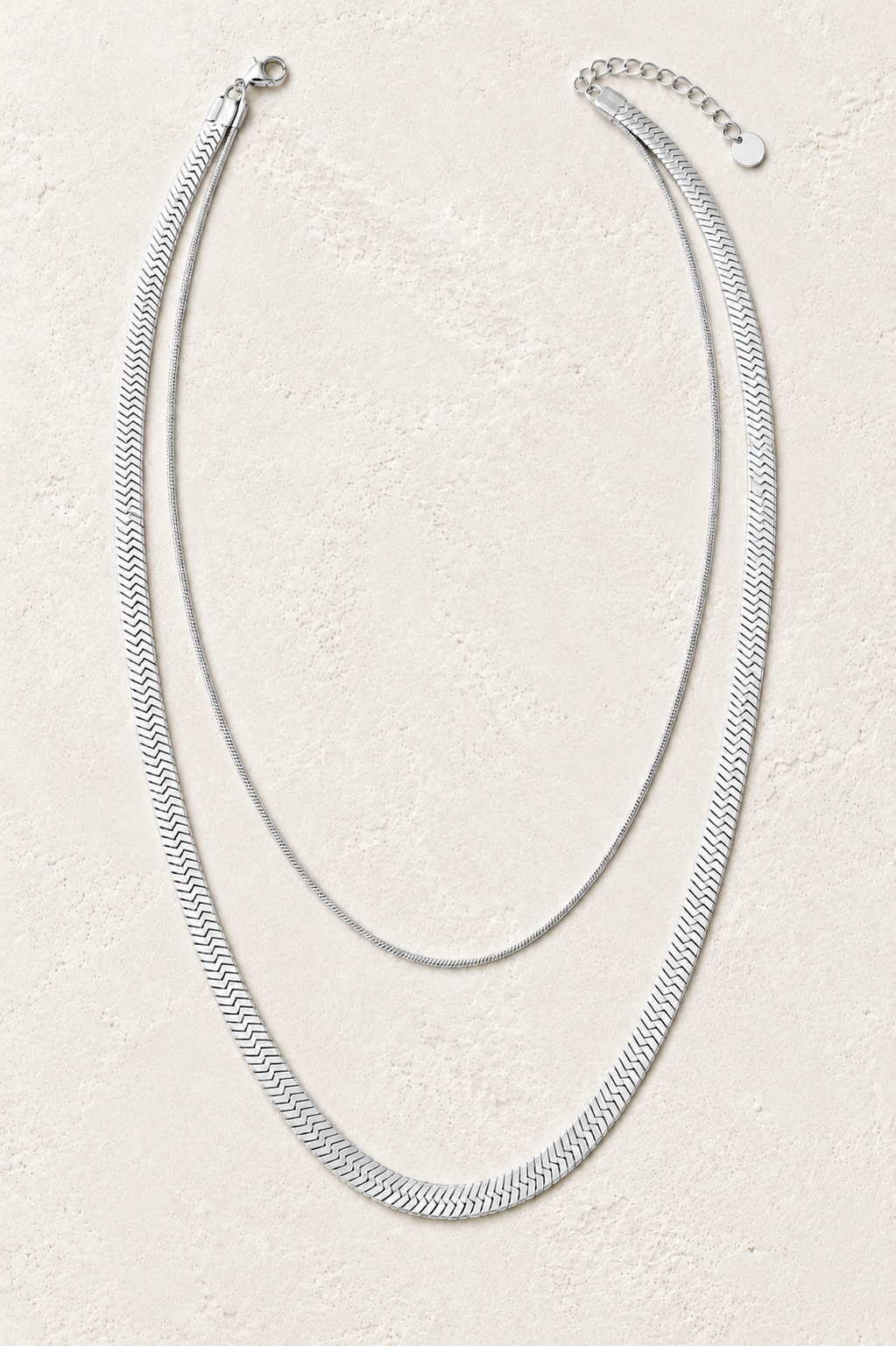 Luna Silver Double Layer Herringbone Necklace on the Boho & Mala cream stone hero background