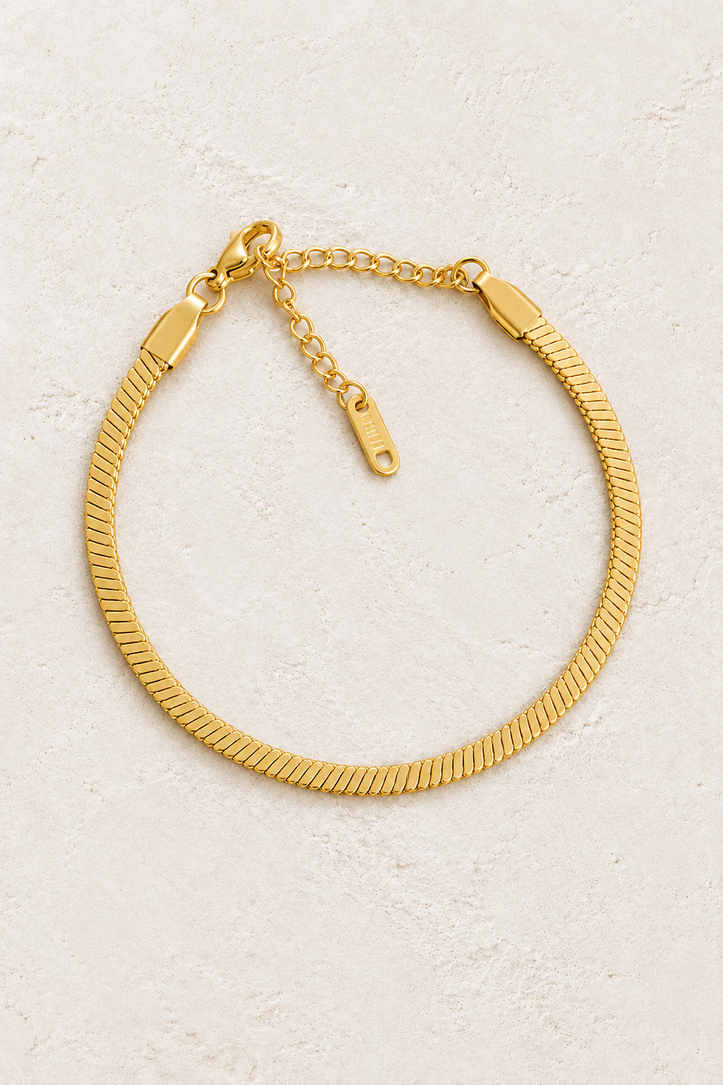 
                  
                    Gold Flat Chain Bracelet on ivory stone
                  
                