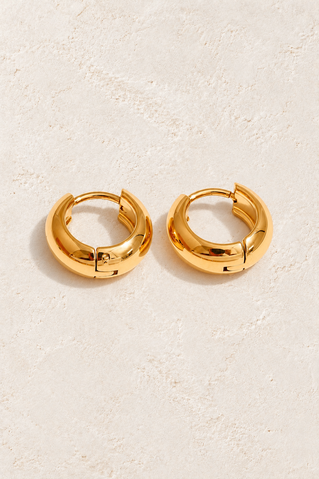 
                  
                    Classic gold waterproof hoop earrings — 8 mm on approved cream background
                  
                