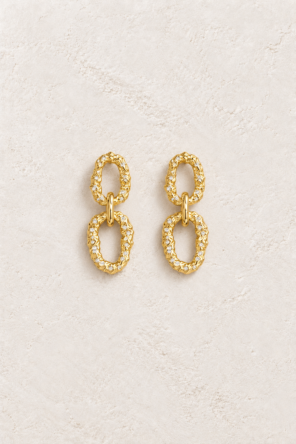 Boho & Mala Gold Plated Earrings on warm ivory textured background