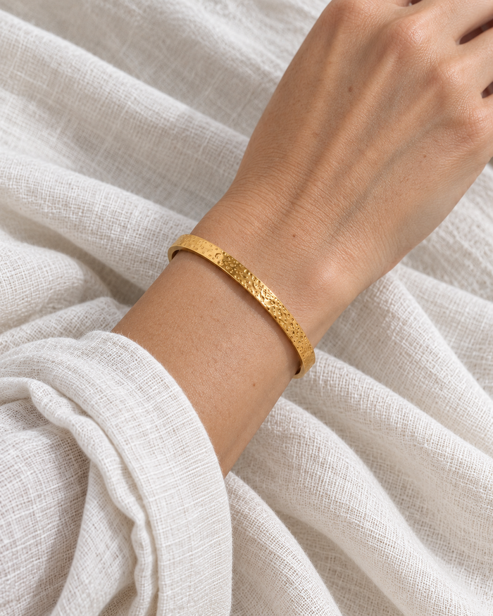 Model wearing Boho & Mala Classic Textured Gold Cuff in natural daylight