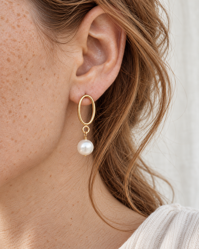 Model wearing Boho & Mala Aveline Classic Pearl Drop Earrings in natural daylight