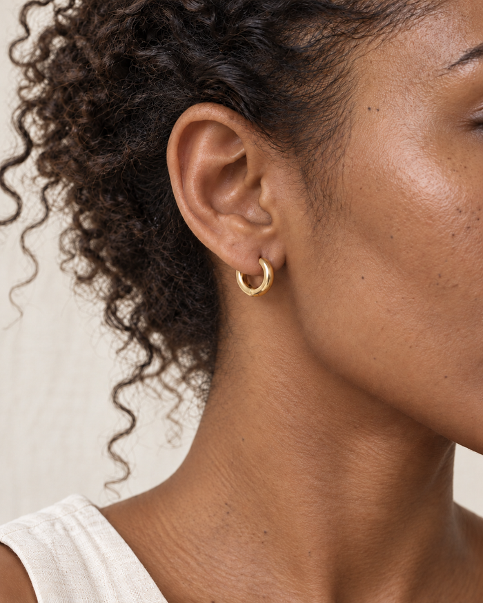 Model wearing Boho & Mala Gold 7mm - Classic Waterproof Hoop Earrings in natural daylight