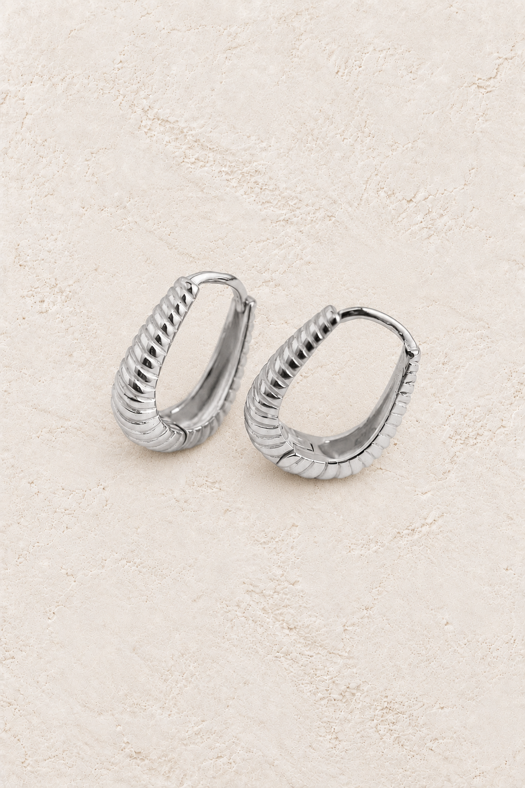 Boho & Mala Huggies Sterling Silver Hoop Earrings DE100069 on warm cream textured background
