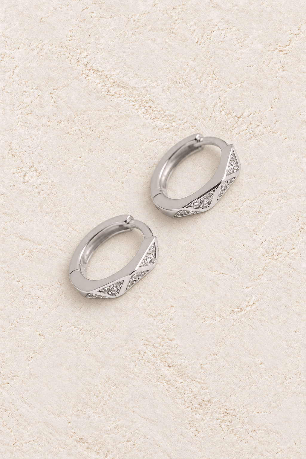 
                  
                    Boho & Mala Huggies Sterling Silver Hoop Earrings DE100068 on warm cream textured background
                  
                