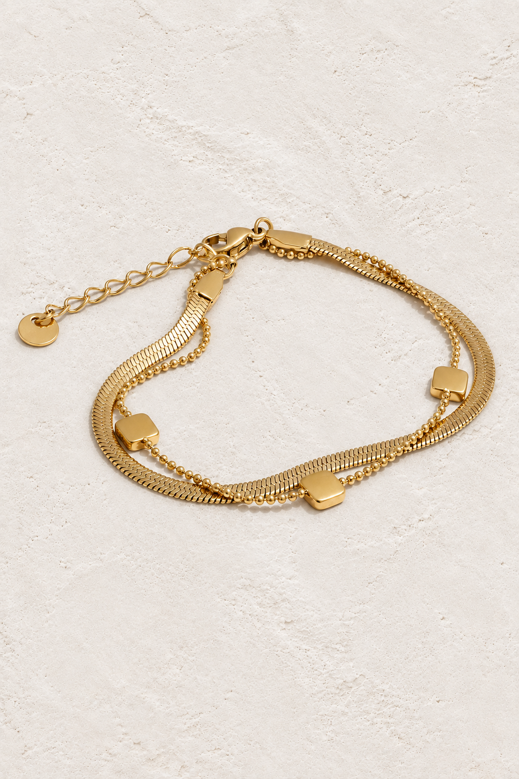 
                  
                    Gold Layered Square Charm Bracelet on ivory stone
                  
                