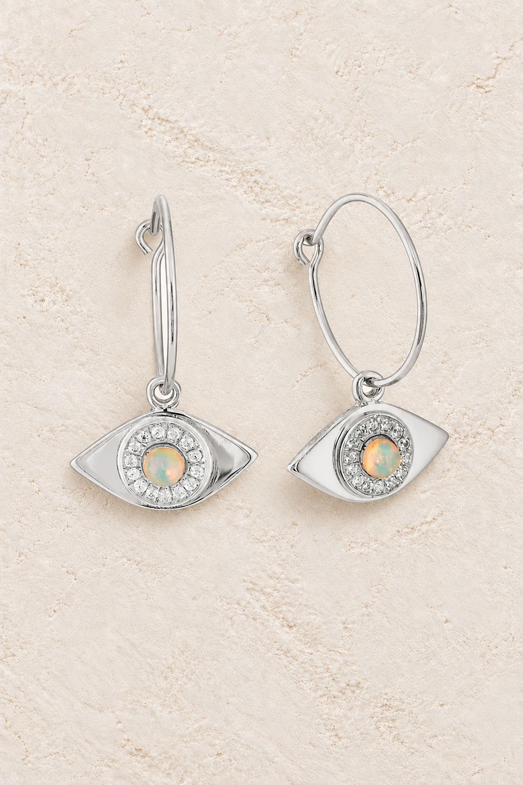 Boho & Mala Opal Eye Sterling Silvet Hoop Earrings on warm cream textured background
