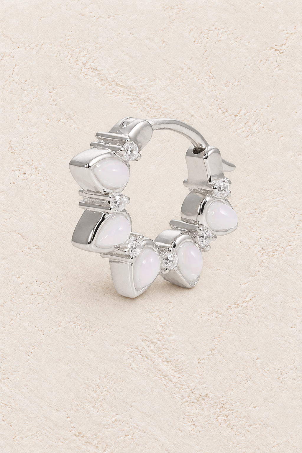 Boho & Mala Opal Sterling Silver Hoop Huggie Earrings on warm cream textured background