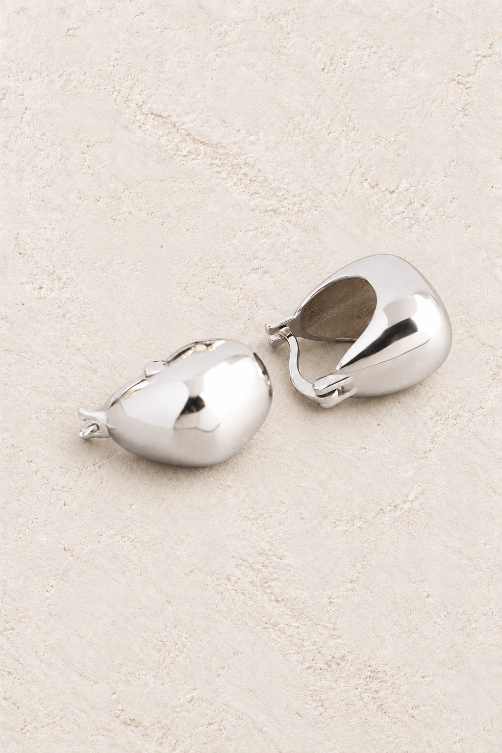 Boho & Mala Sterling Silver Hoop Earrings on warm cream textured background