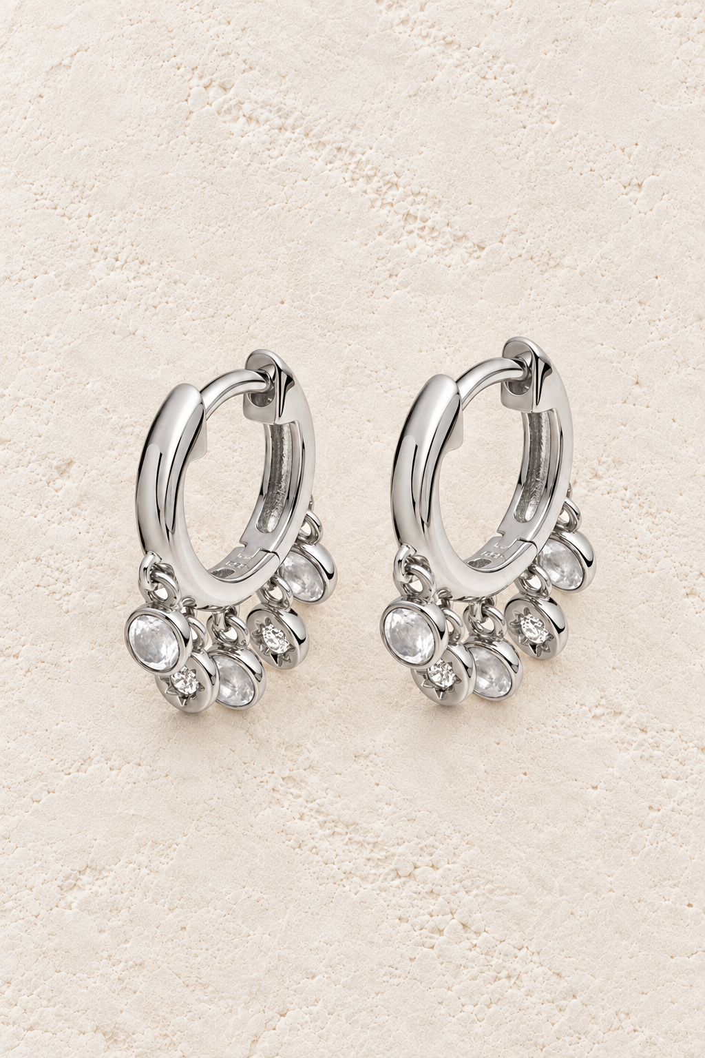 Boho & Mala Sterling Silver Hoop Earrings on warm cream textured background