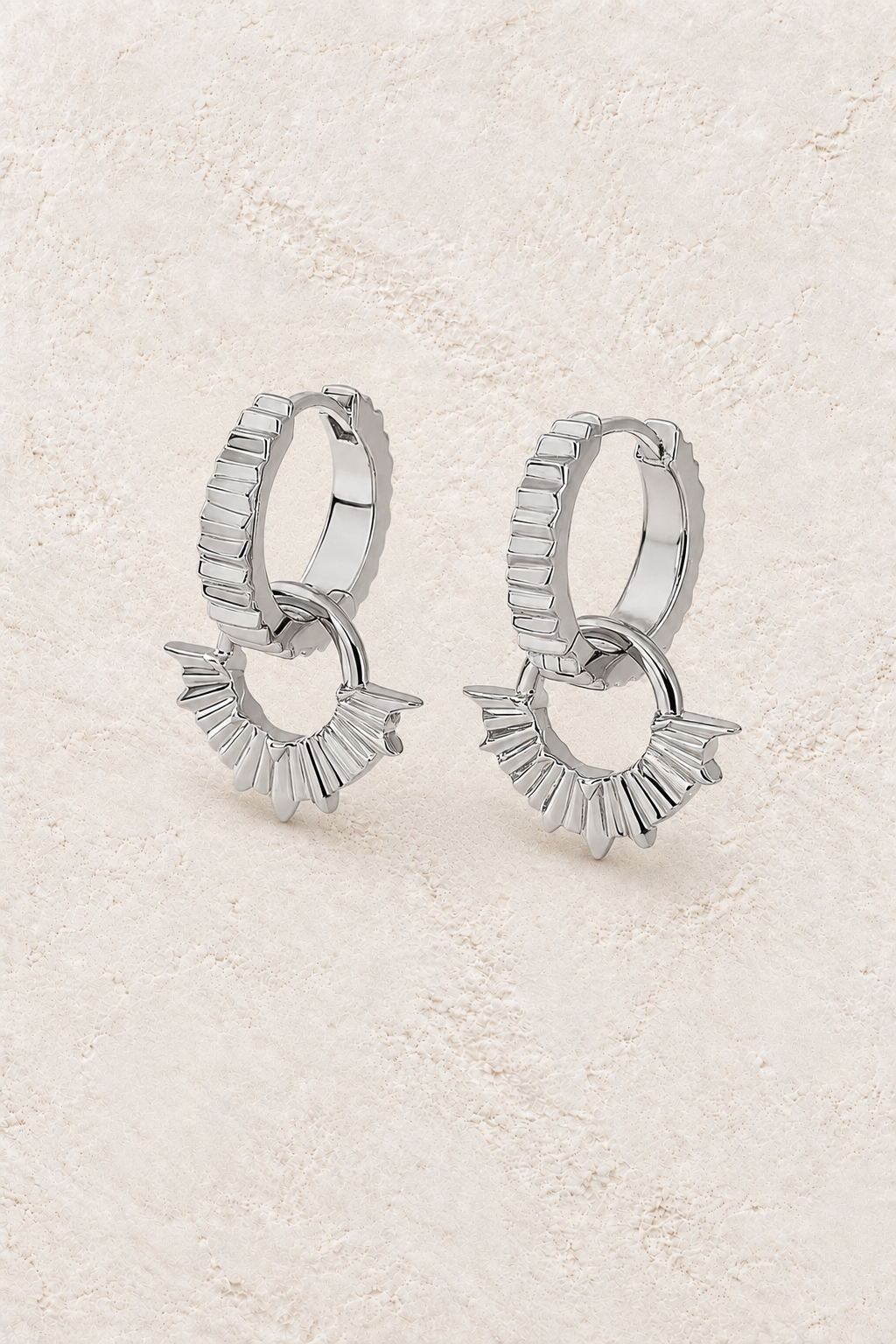 Boho & Mala Sterling Silver Hoop Huggie Earrings on warm cream textured background