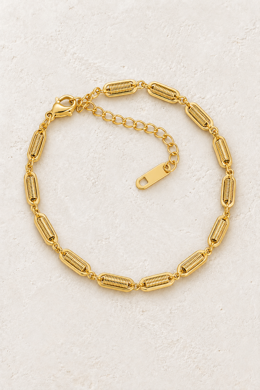 
                  
                    Gold Textured Link Bracelet on ivory stone
                  
                