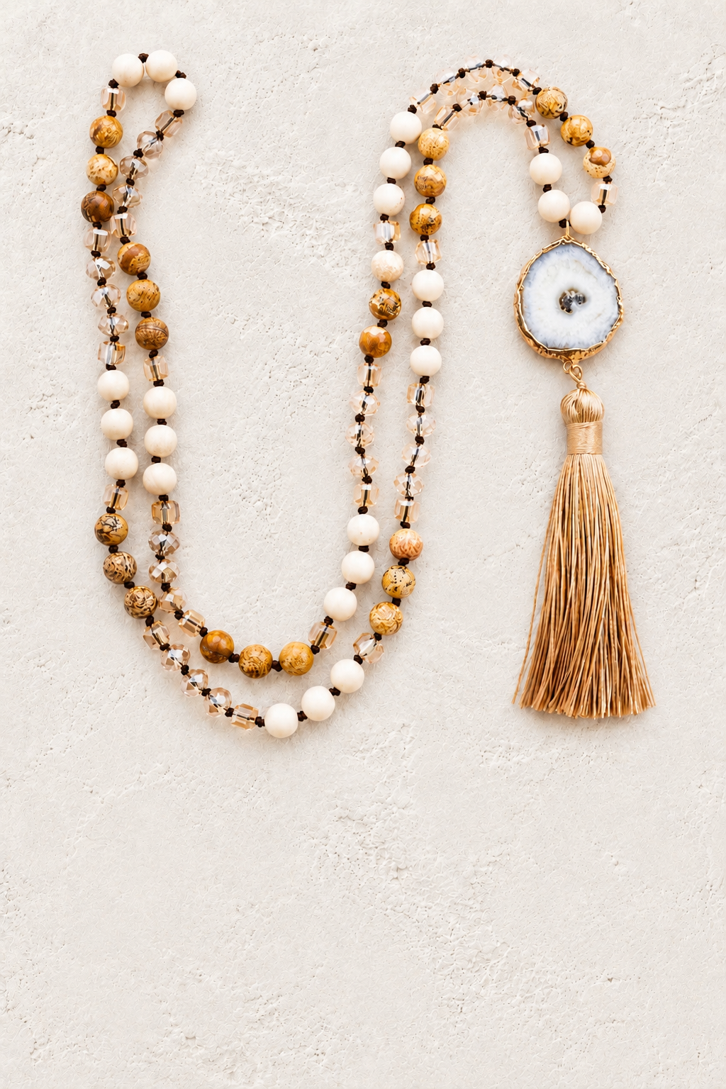 Solar Quartz Agate Slice Tassel Necklace II on the Boho & Mala cream stone hero background