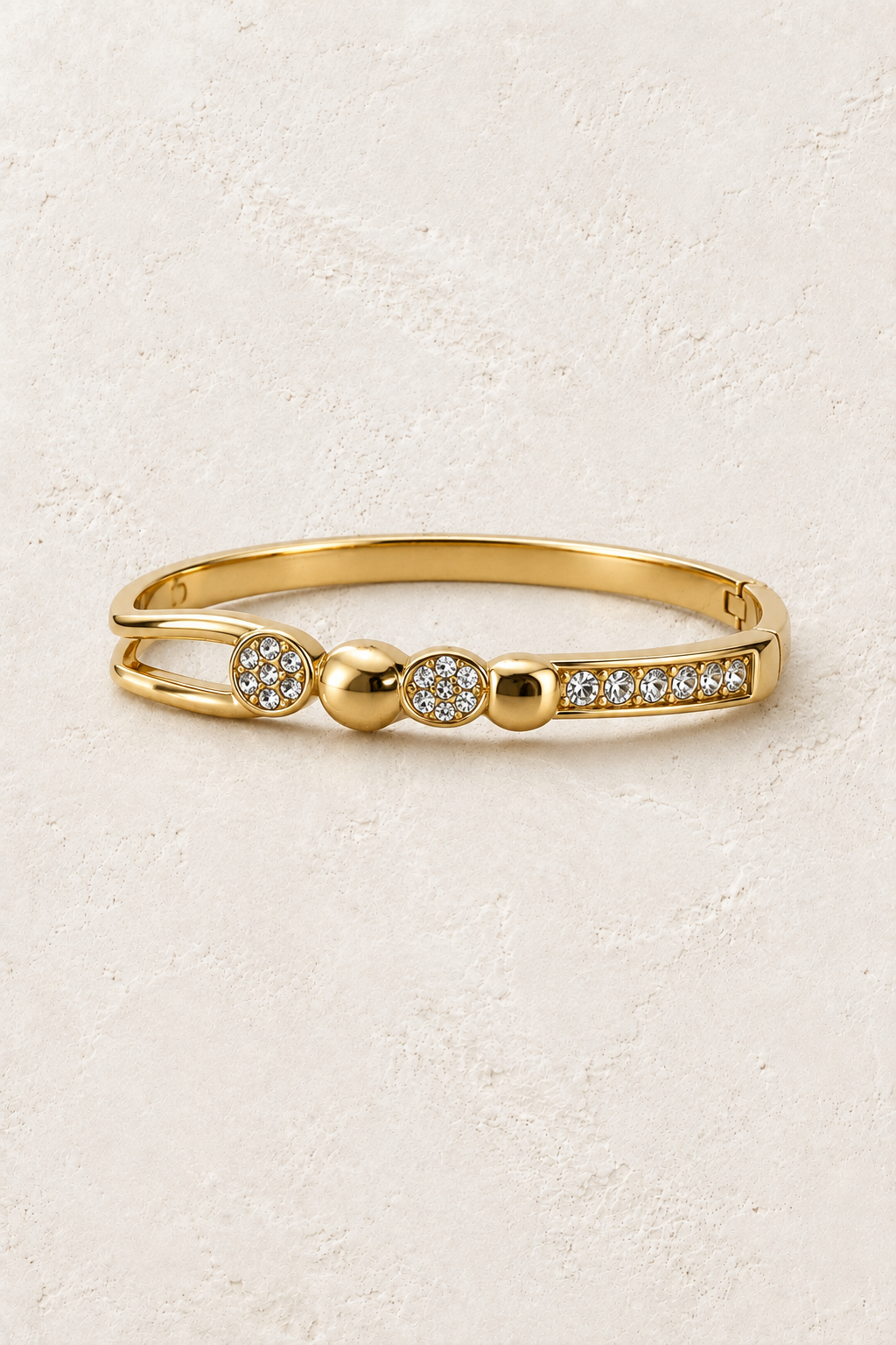 
                  
                    Gold Crystal Disc Detail Bangle | Waterproof on ivory textured background
                  
                