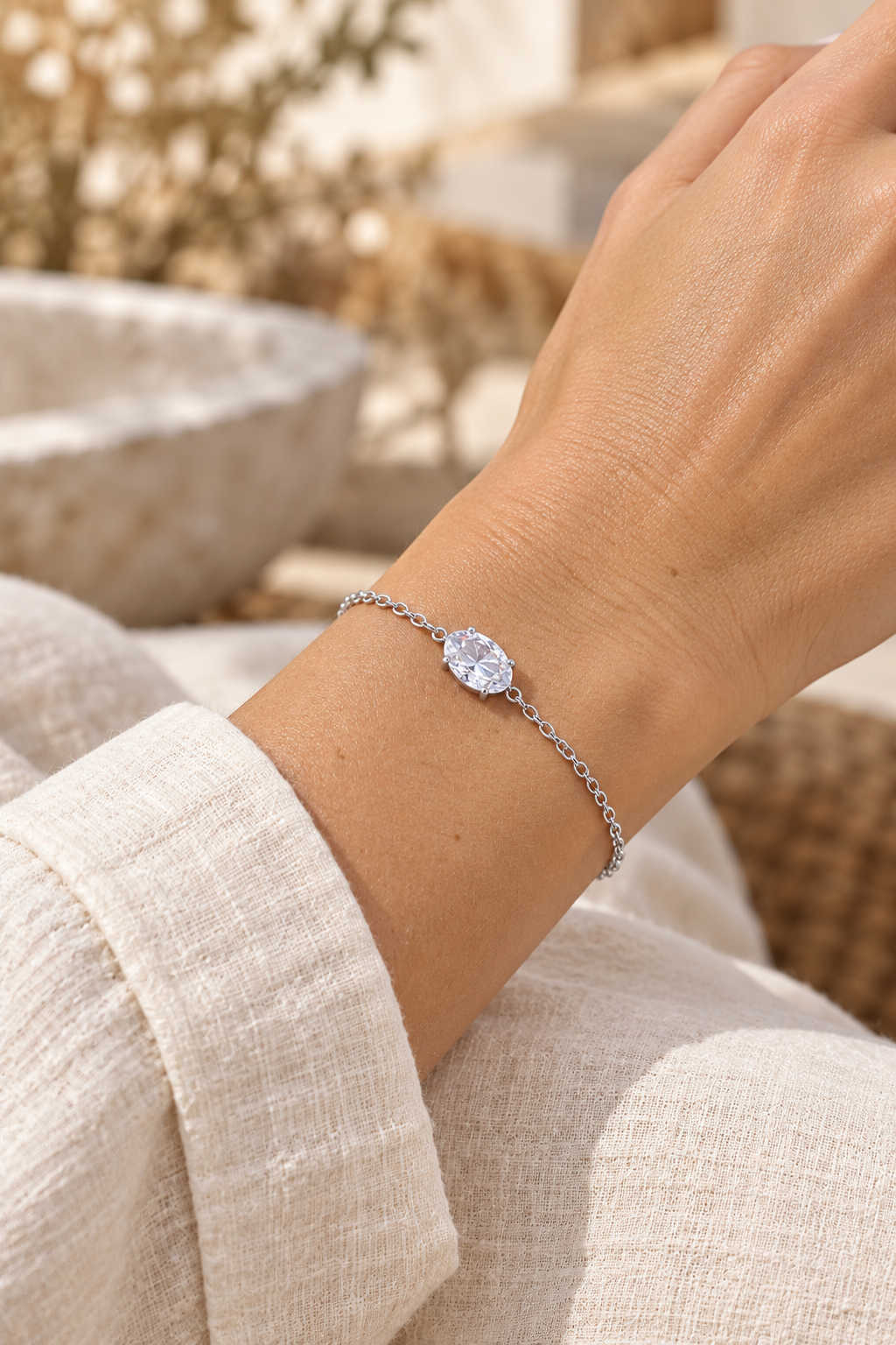Oval Solitaire Cubic Zirconia Chain Bracelet – Silver worn on model wrist – AI styling illustration
