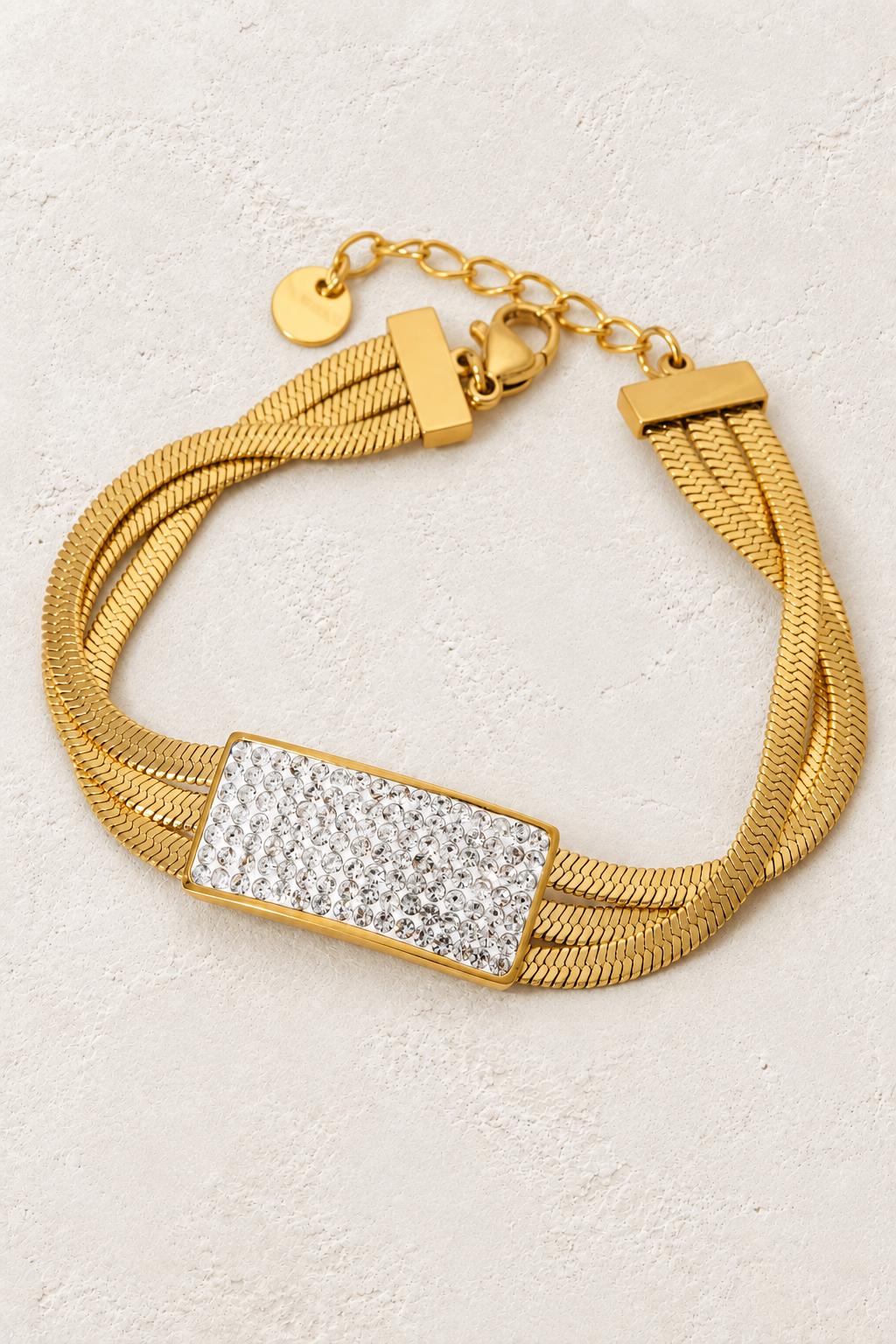
                  
                    Luxe Pavé Bar Gold Snake Chain Bracelet on ivory textured background
                  
                