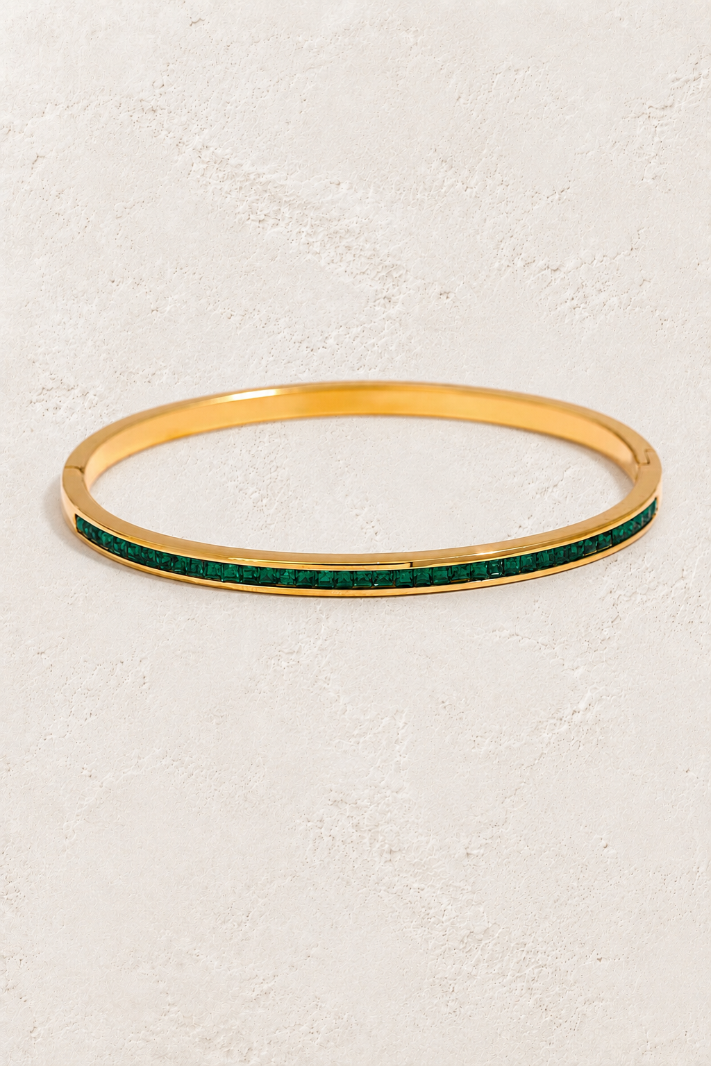 
                  
                    Serene Gold Green Crystal Bangle on ivory textured background
                  
                