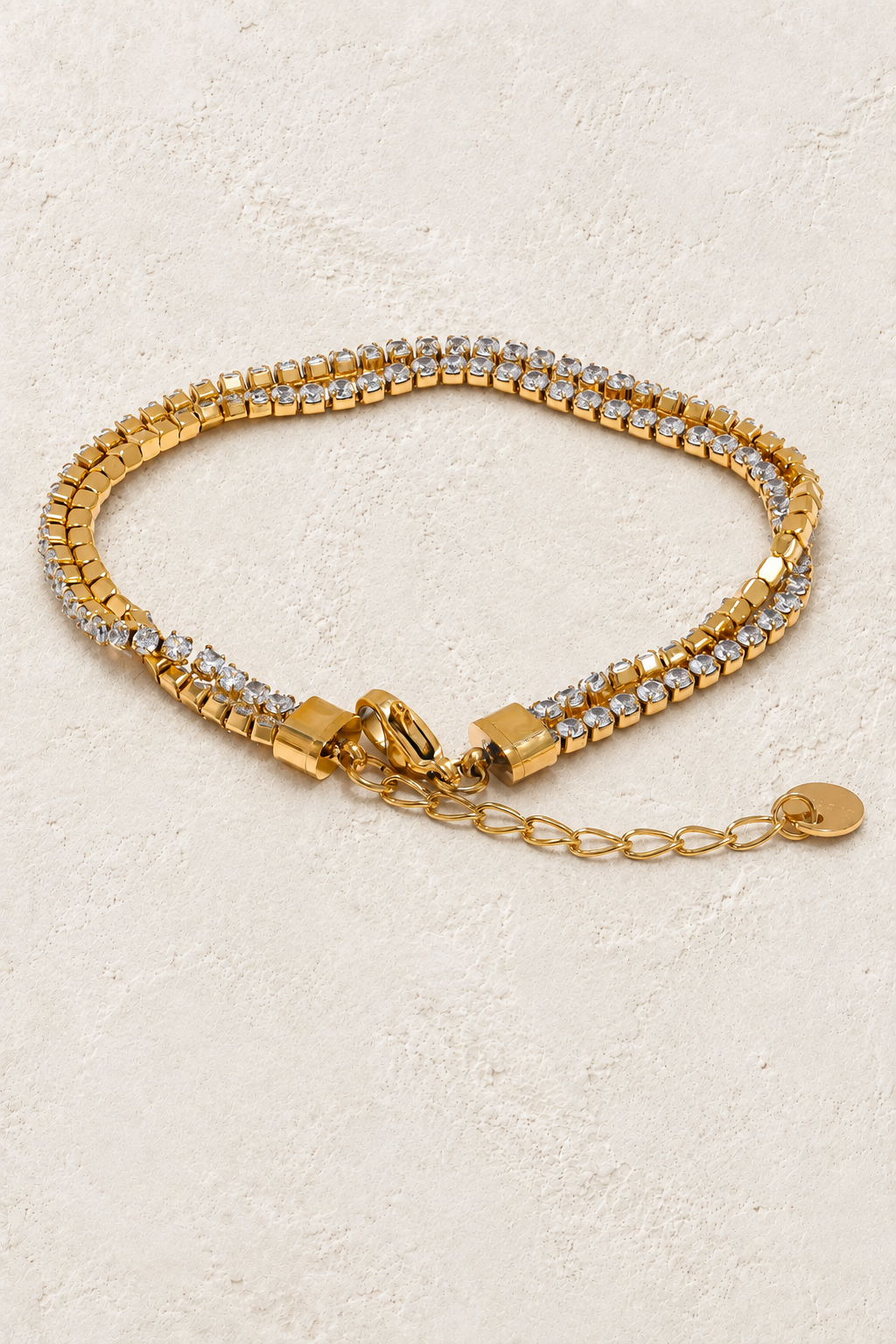 
                  
                    Golden Glow Crystal Layered Bracelet on ivory textured background
                  
                