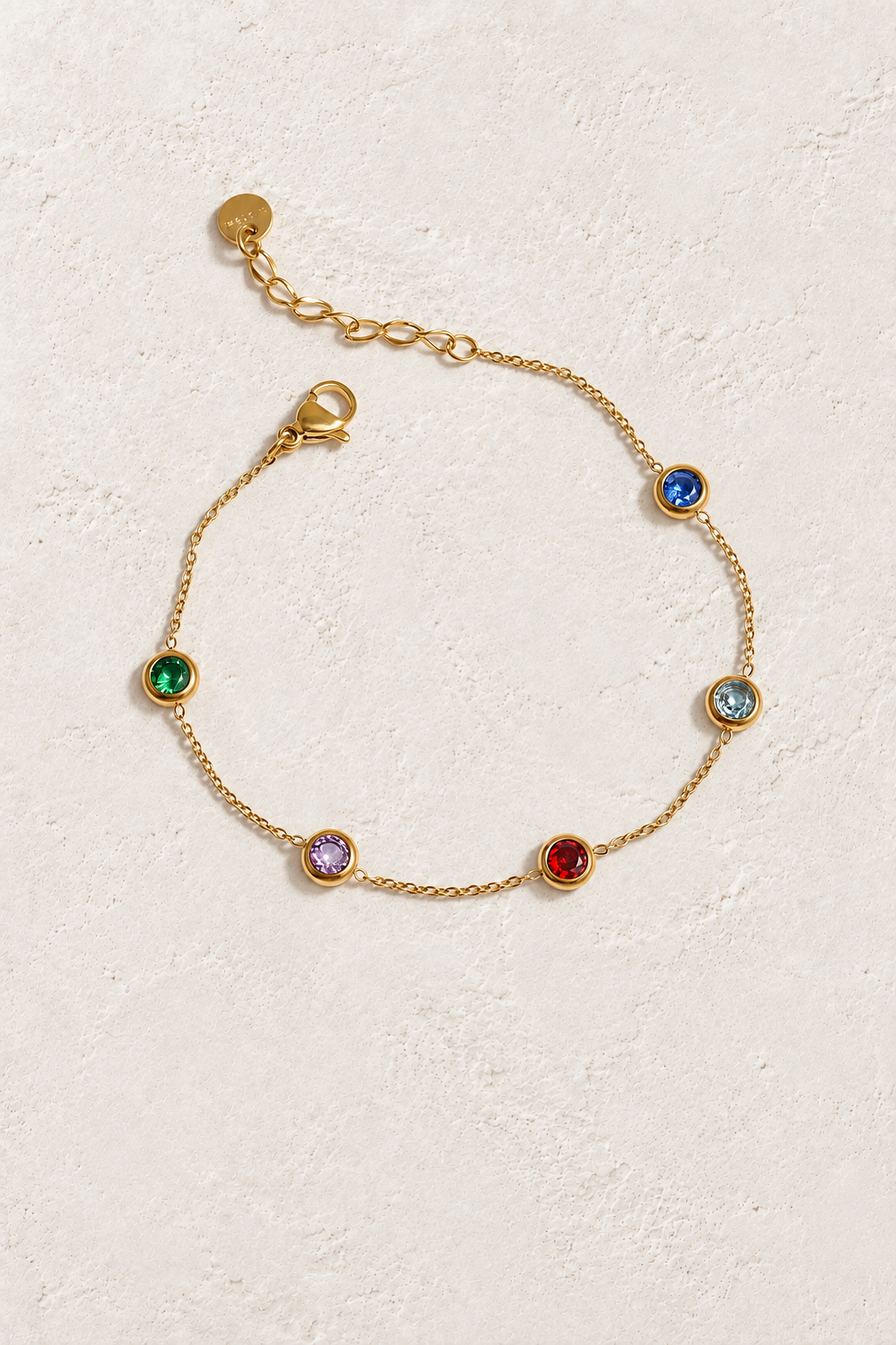
                  
                    Rainbow Crystal Gold Bracelet on ivory textured background
                  
                