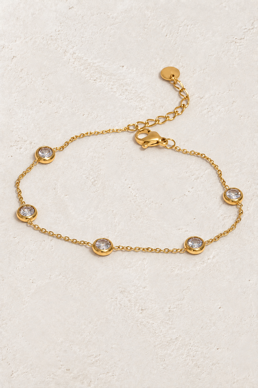 Crystal Station Gold Bracelet on ivory textured background