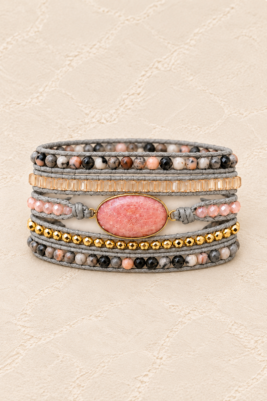 Handmade Pink Rhodonite Mixed Natural Stone Wrap Bracelet on ivory plaster, tall product cover