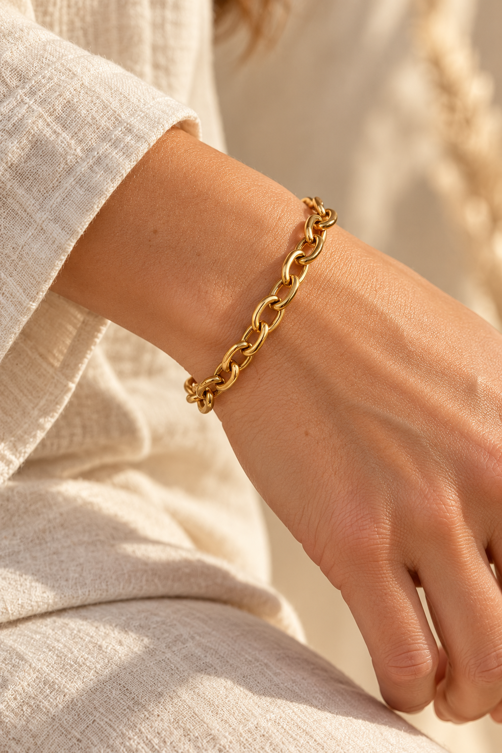 
                  
                    Brielle Gold Classic Oval Link Bracelet worn on a model's wrist
                  
                
