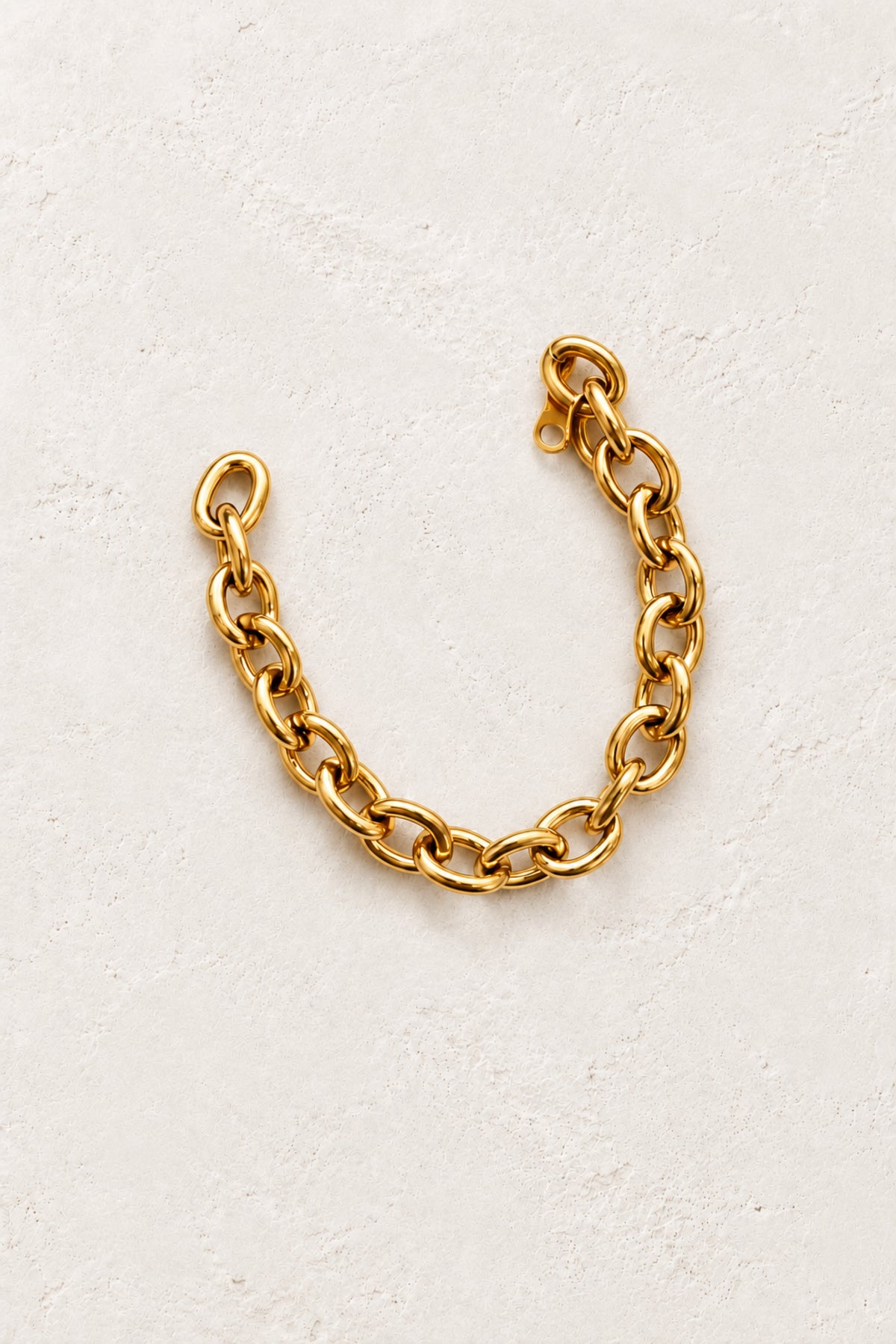 
                  
                    Brielle Gold Classic Oval Link Bracelet on the approved Boho & Mala ivory plaster background
                  
                