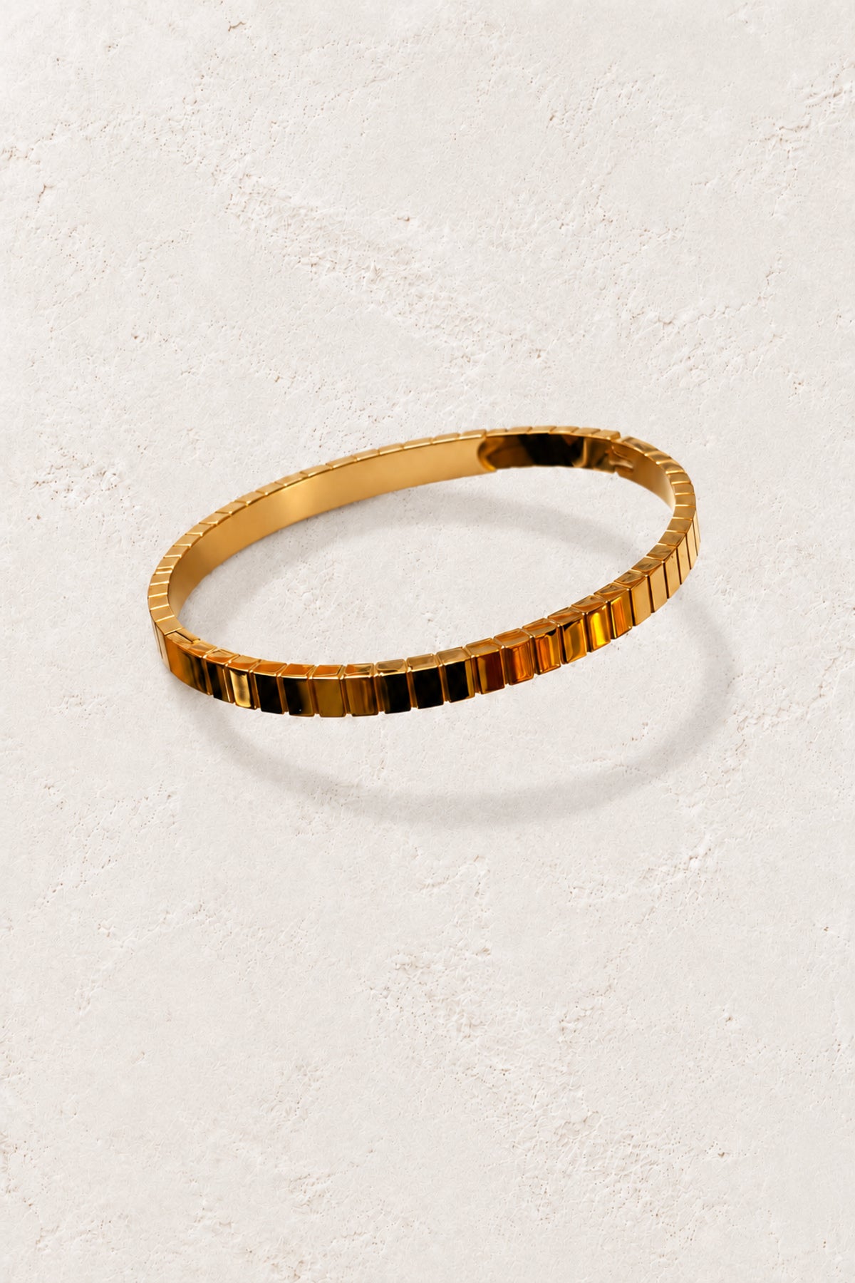 
                  
                    Brisa Max Gold Ribbed Bangle on the approved Boho & Mala ivory plaster background
                  
                