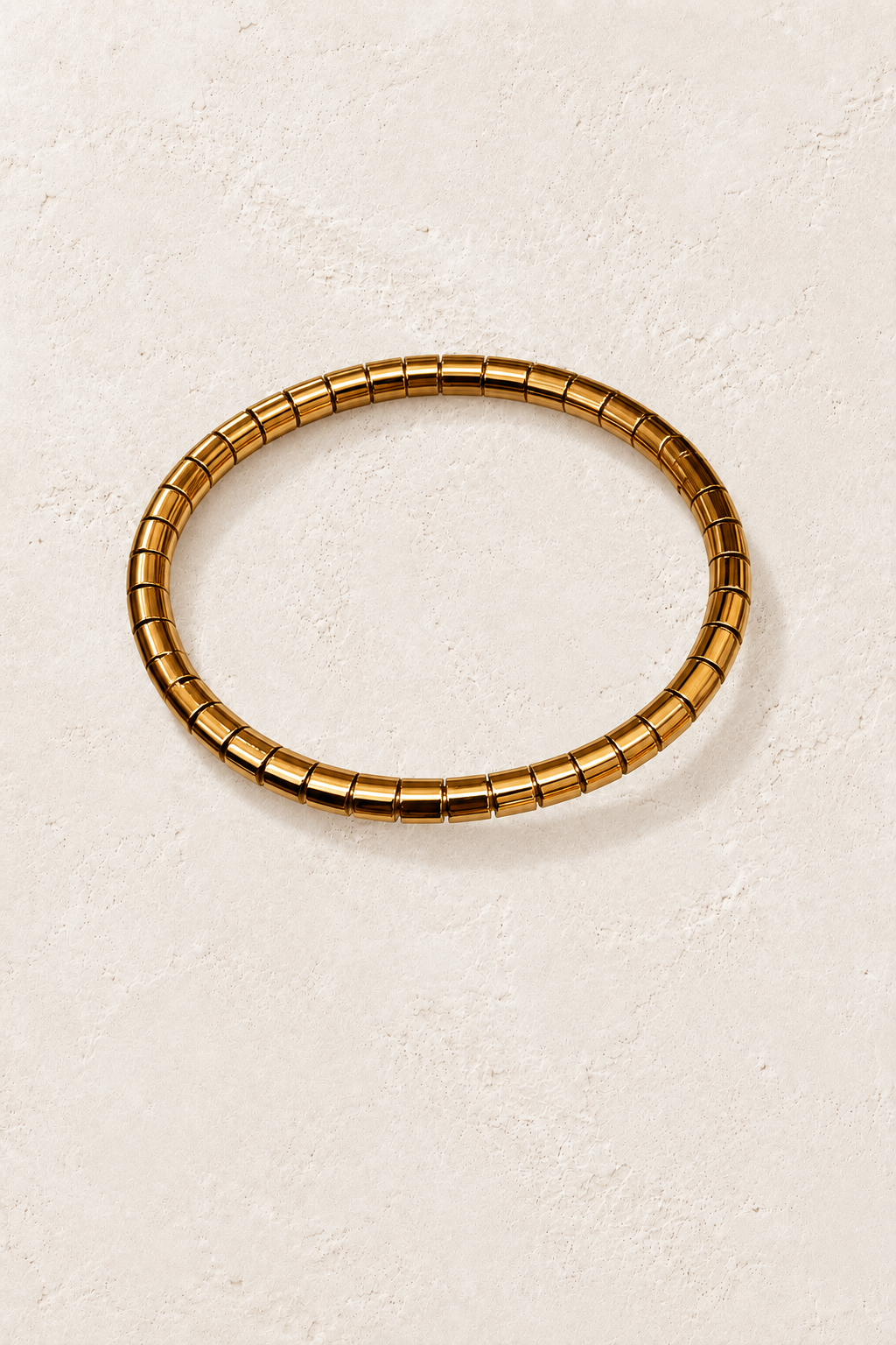 
                  
                    Brisa Midi Oval Gold Ribbed Bangle on cream beige textured background
                  
                