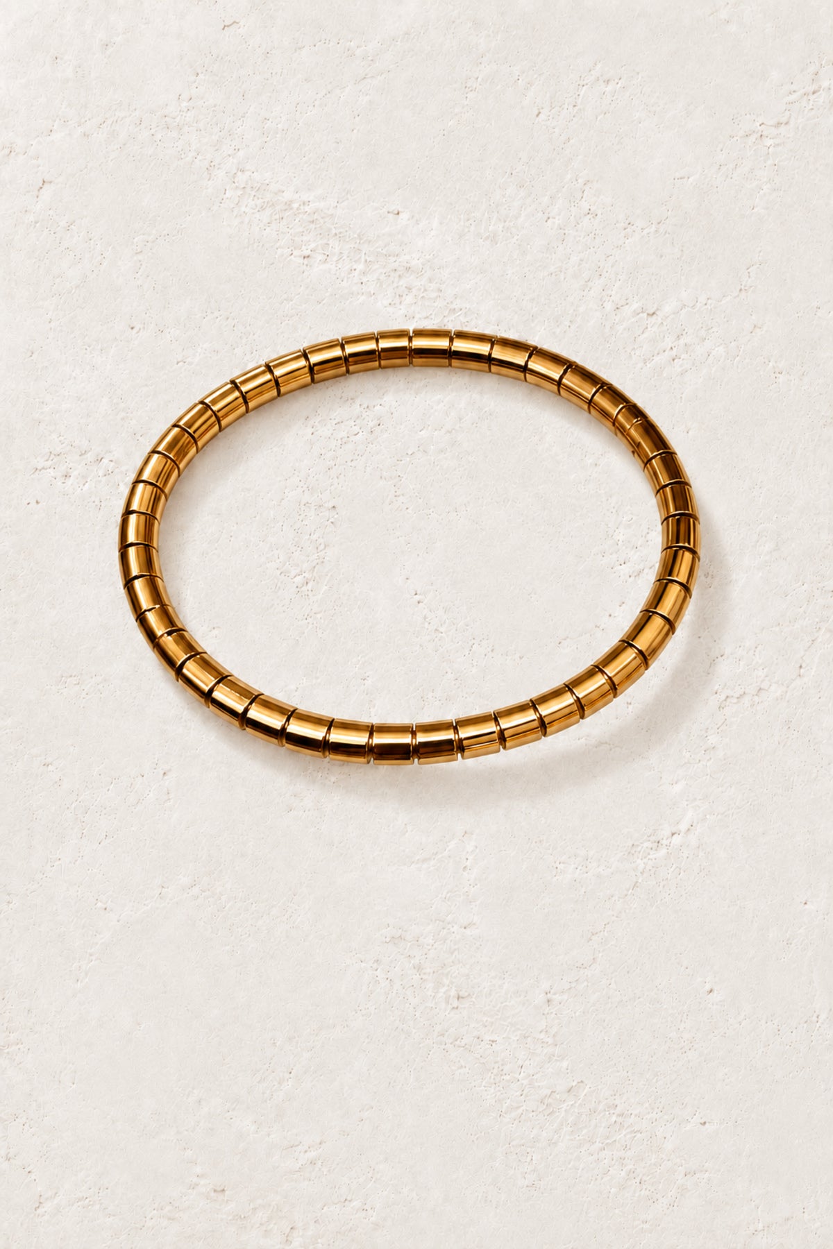 
                  
                    Brisa Midi Oval Gold Ribbed Bangle on the approved Boho & Mala ivory plaster background
                  
                