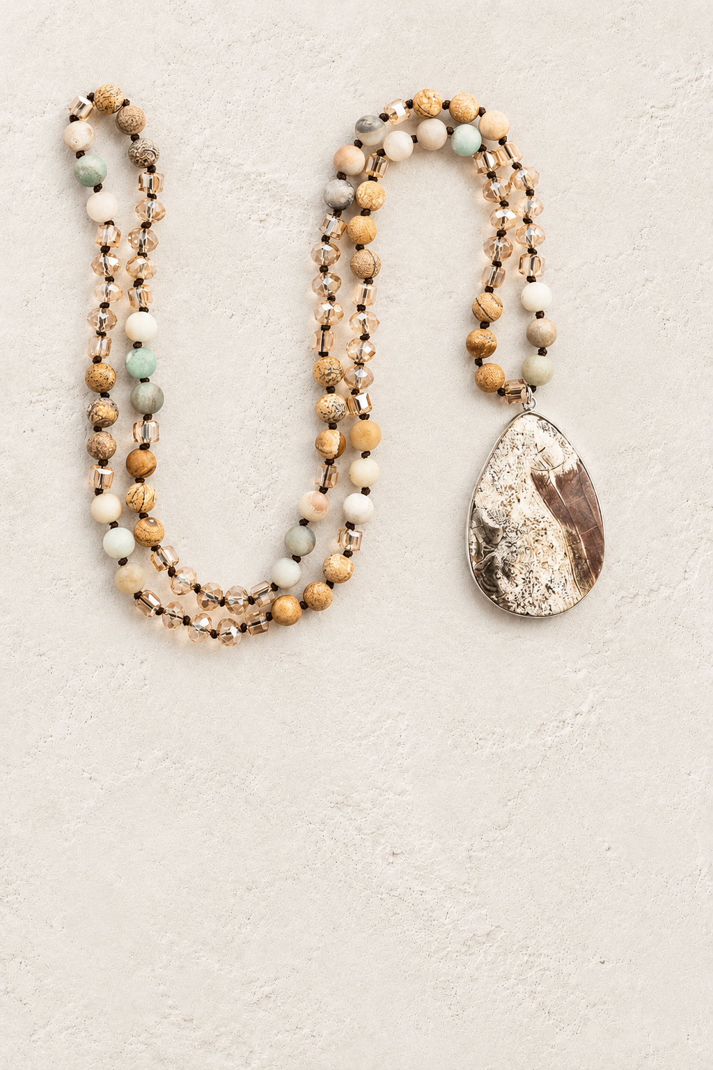 
                  
                    Brown Agate Tribal Necklace II on warm ivory plaster background
                  
                