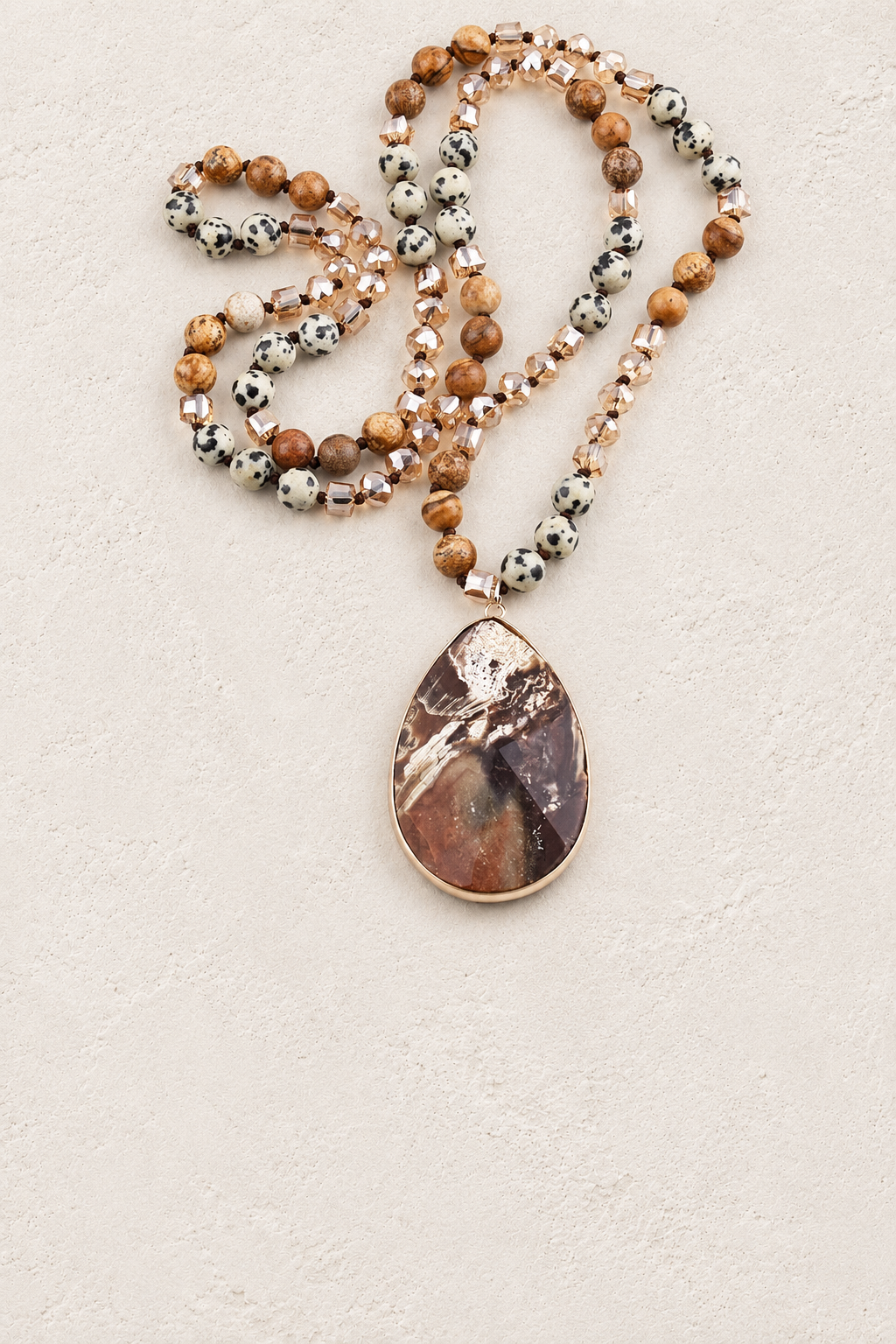 
                  
                    Brown Agate Tribal Necklace III on warm ivory plaster background
                  
                