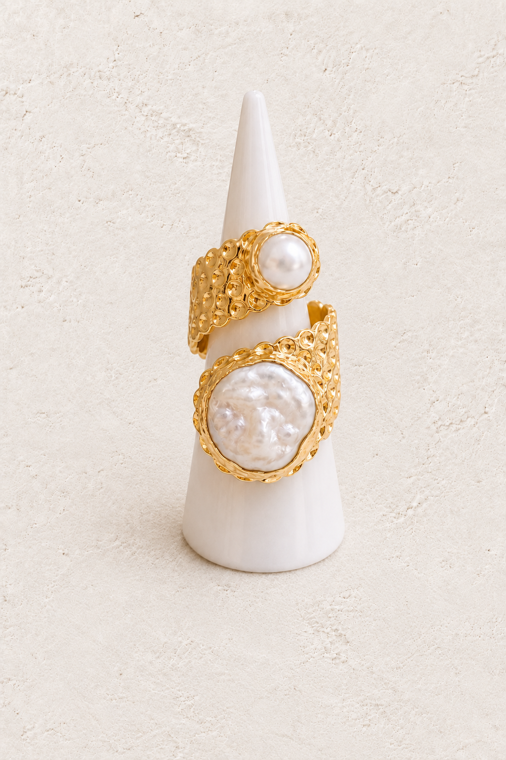 Calista Freshwater Pearl Ring (Adjustable) on white cone against warm textured background