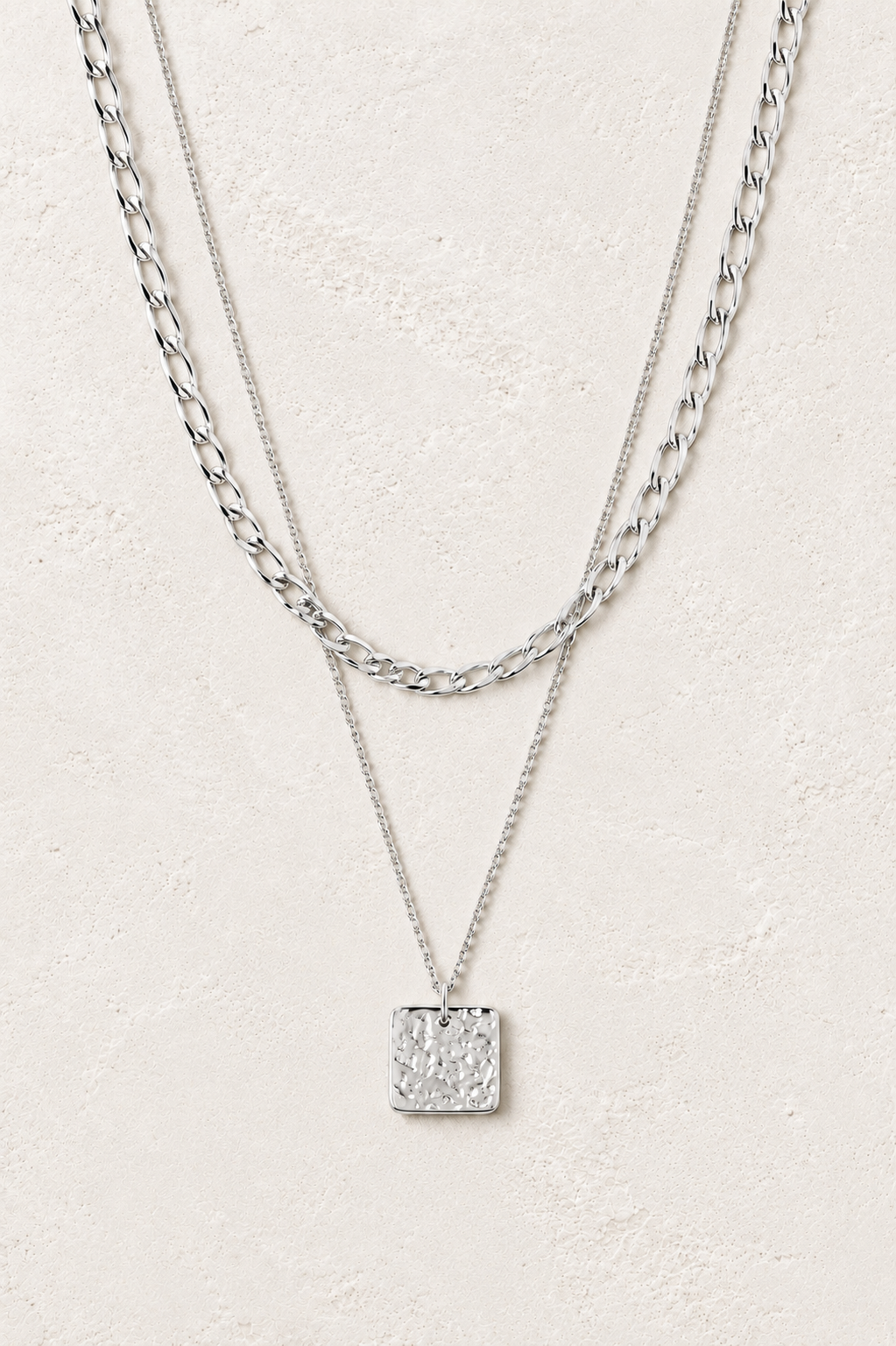 Isla Silver Layered Square Pendant Necklace on the Boho & Mala cream stone hero background