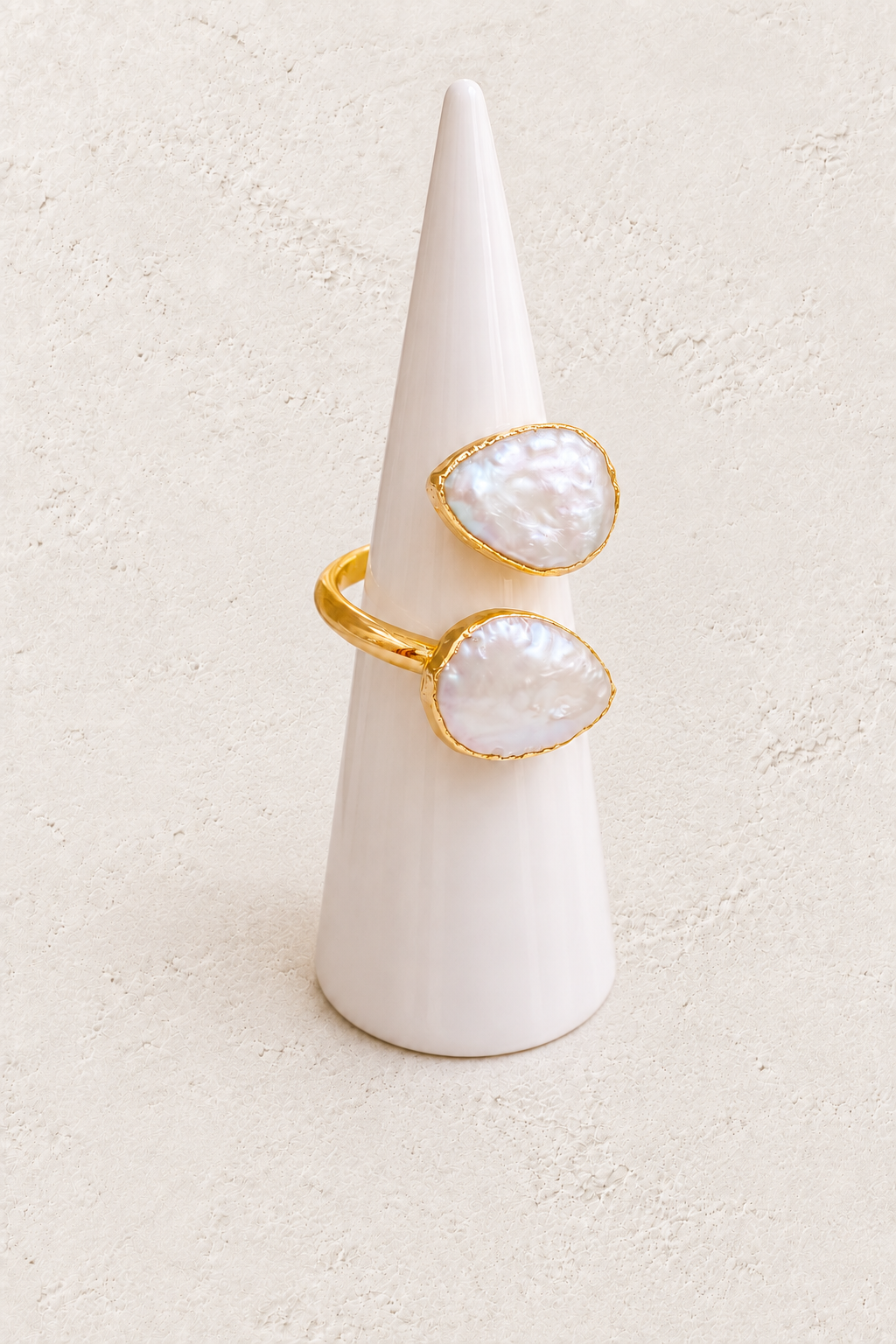 Cavelle Freshwater Pearl Ring (Adjustable) on white cone against warm textured background