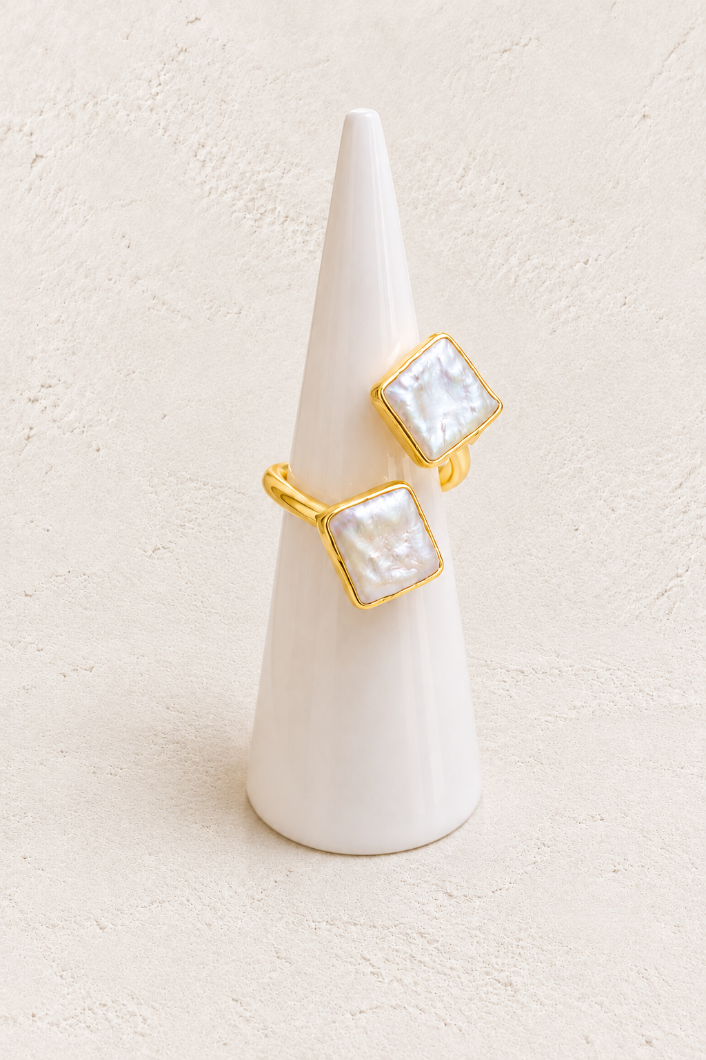 Cavelle Squared Freshwater Pearl Ring (Adjustable) on white cone against warm textured background