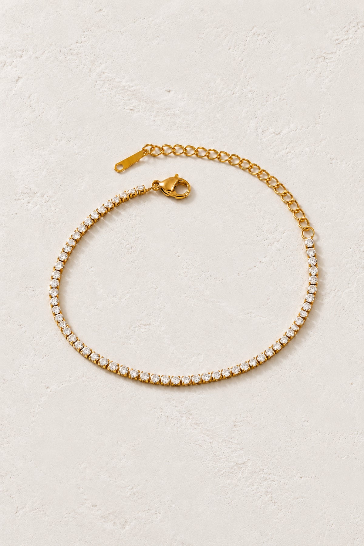 Celeste Gold Crystal Tennis Bracelet on Boho & Mala's ivory plaster background