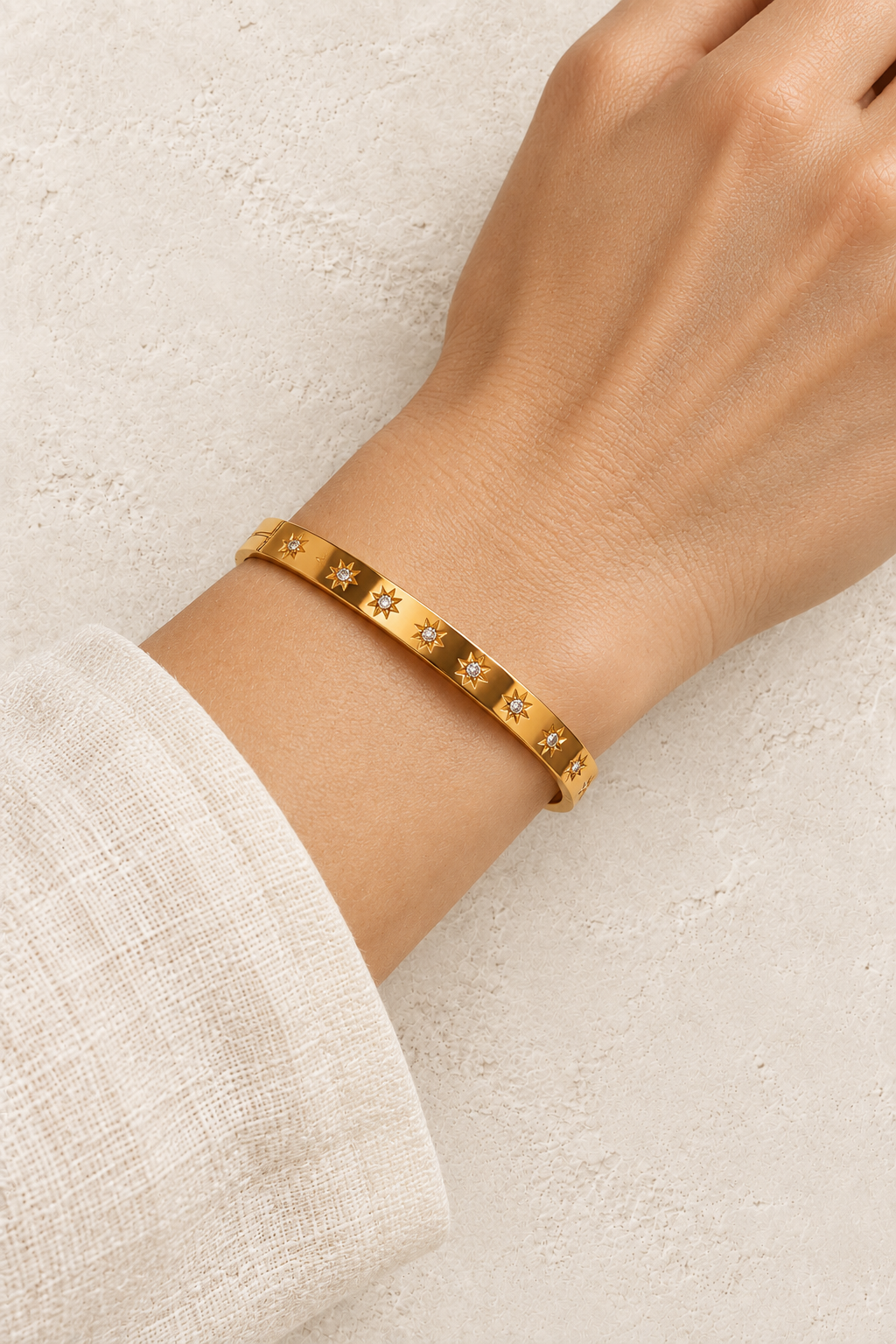 Model wearing Celestia Gold Starburst Bangle