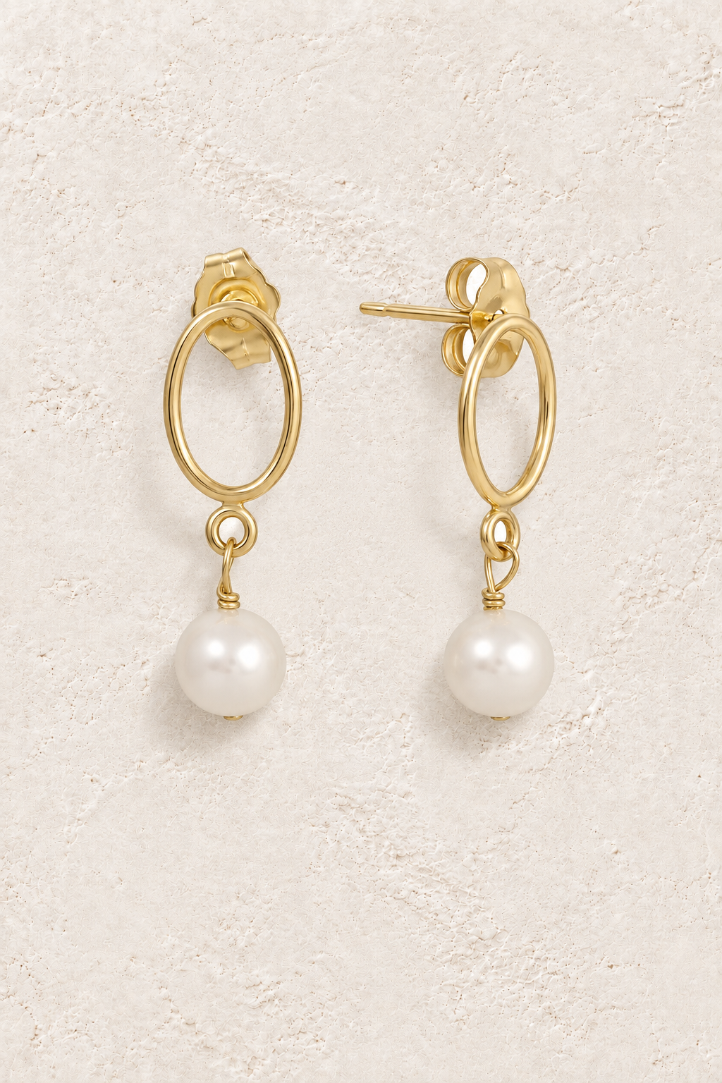 Classic Pearl Oval Drops on warm ivory plaster