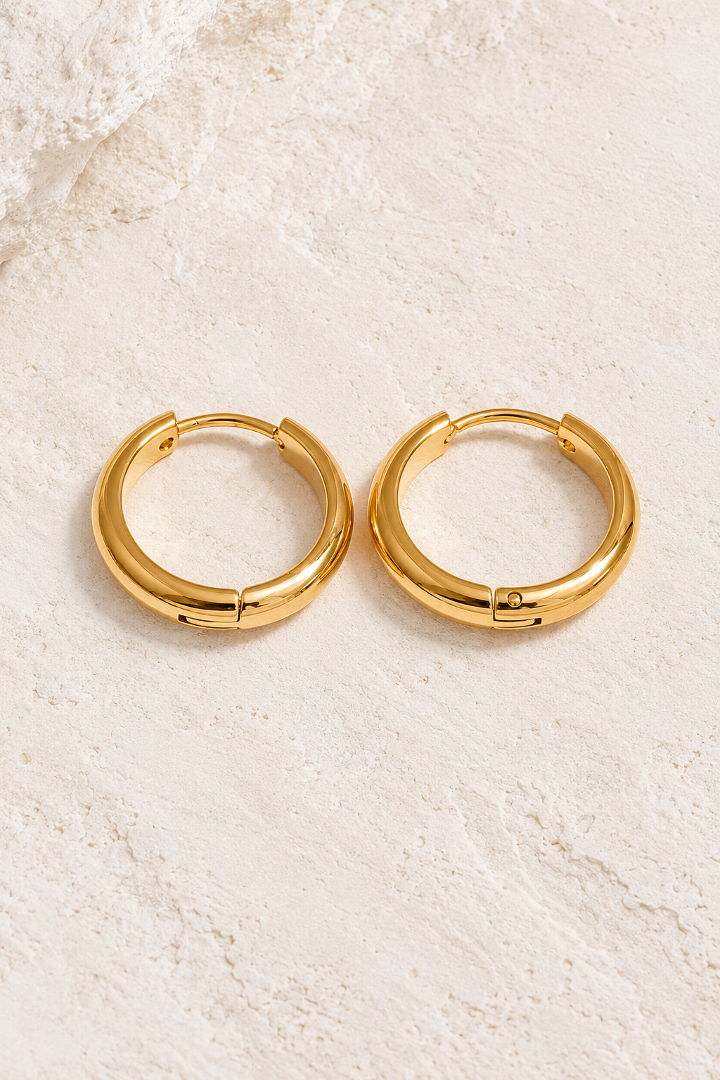 
                  
                    Classic Waterproof Hoop Earrings on cream textured background
                  
                