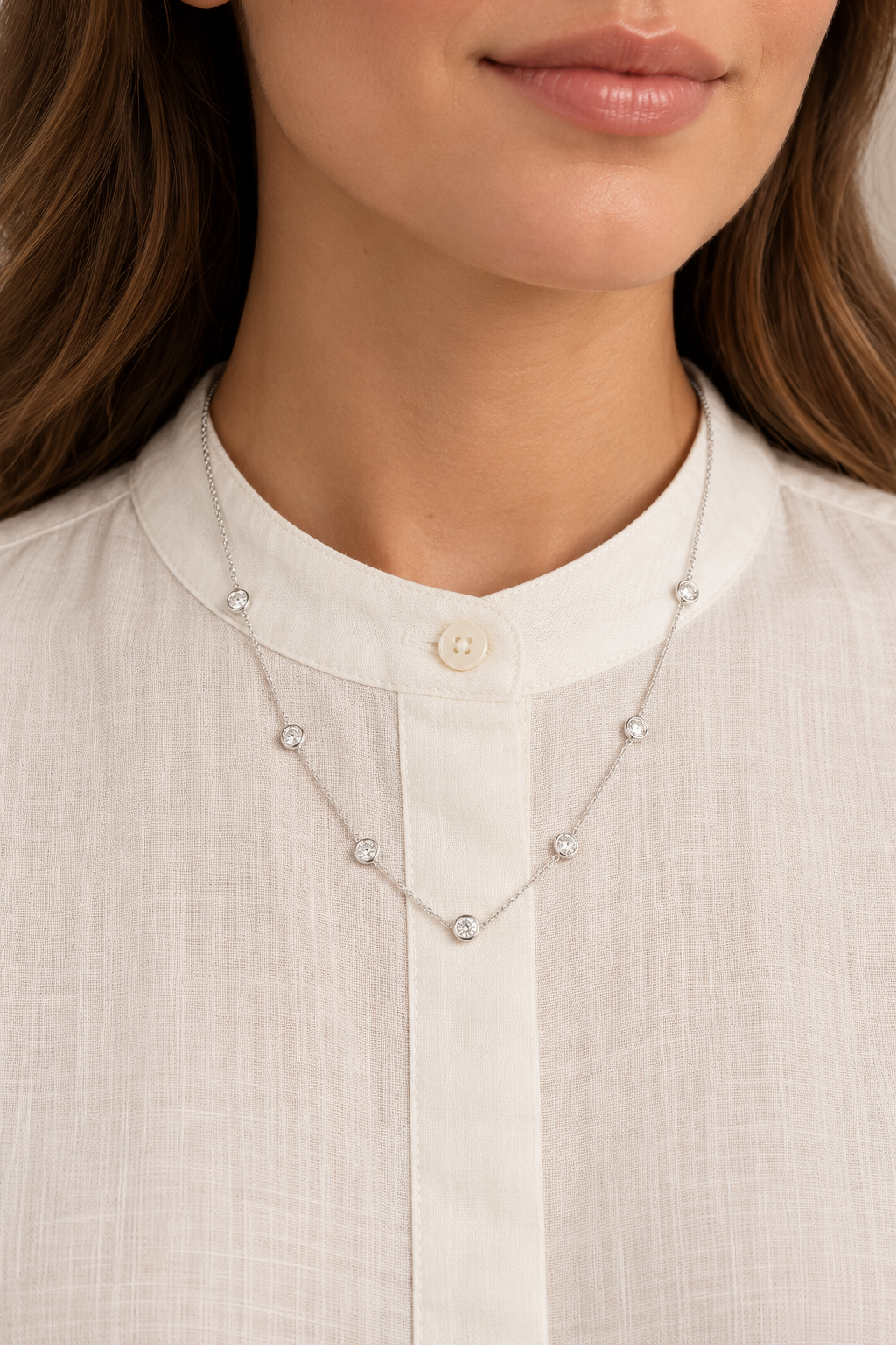 Clear Crystal Silver Necklace with seven clear bezel-set stones worn on a model